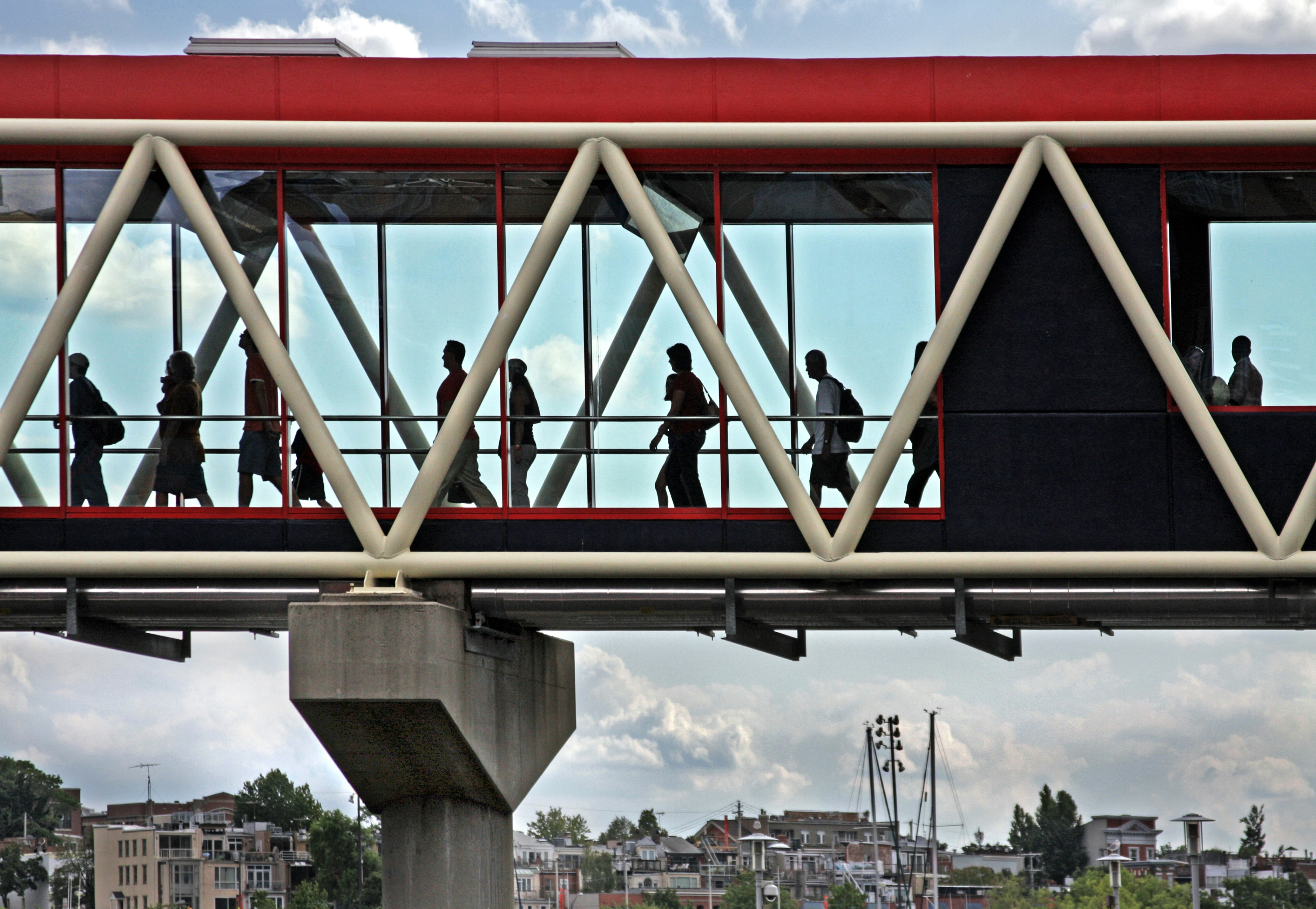 "Walking on Air" --- People walking on an elevated footbridge in Baltimore, Maryland, USA.