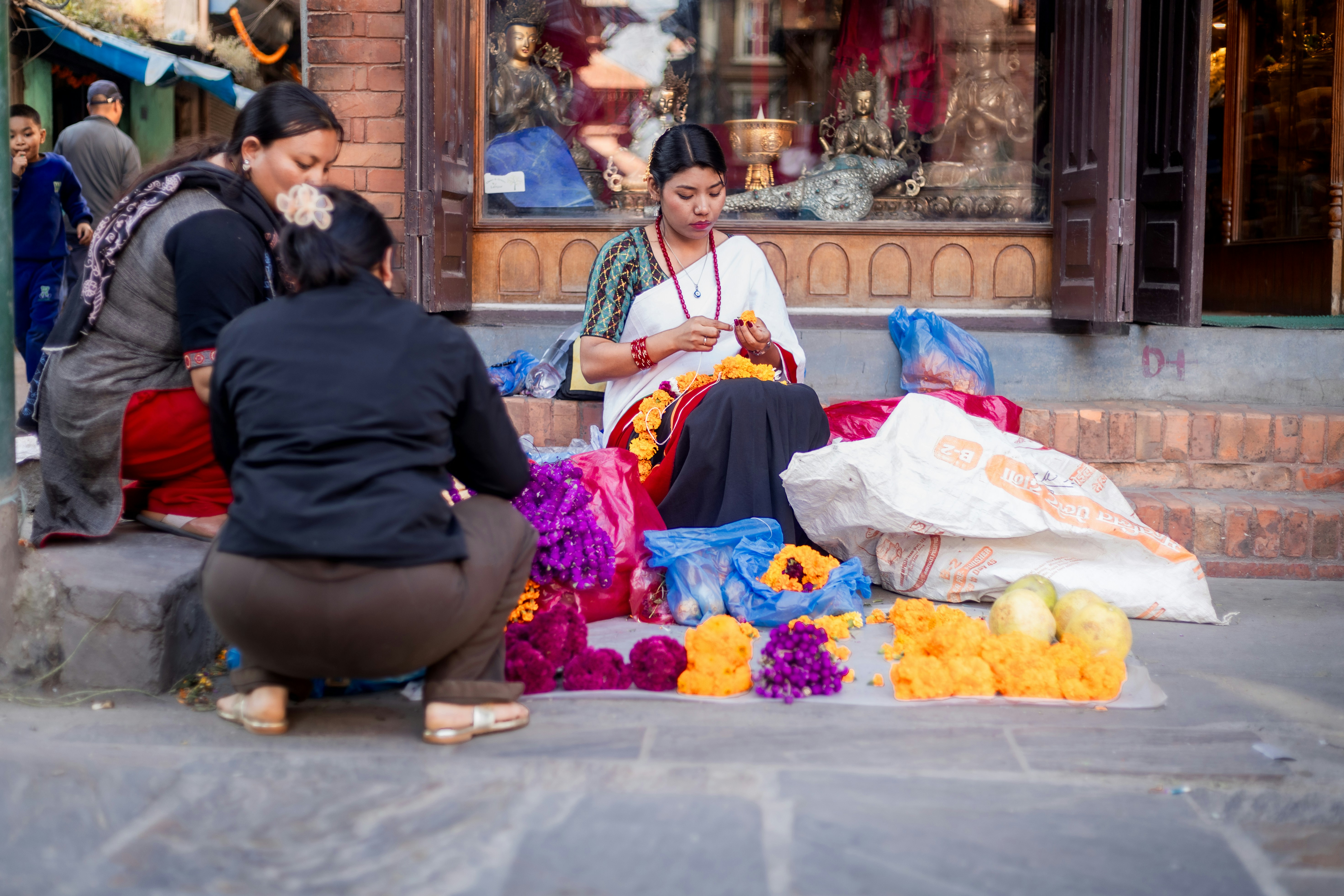 Newari woman crafting traditional garlands