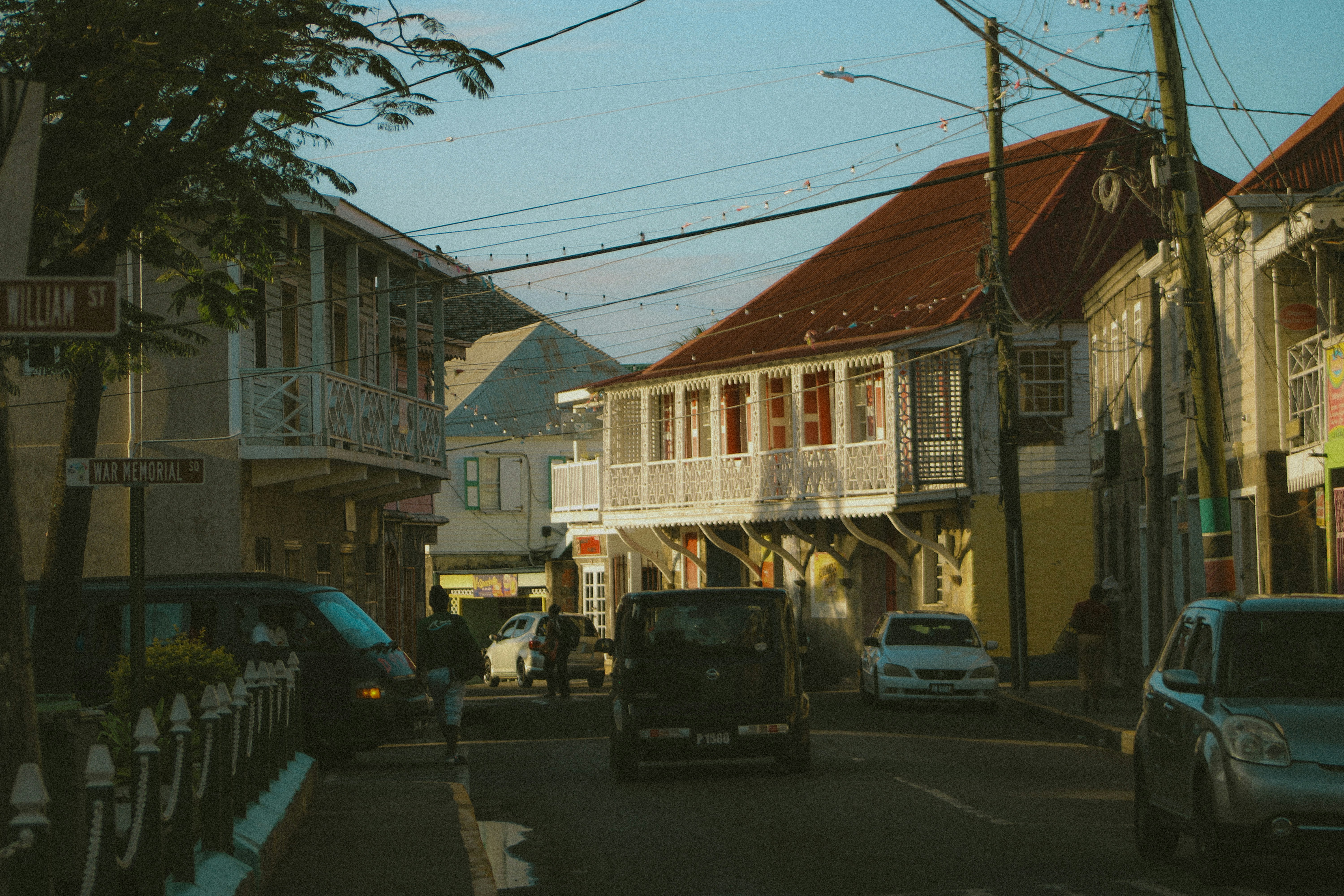 Street scene with cars and colorful buildings.