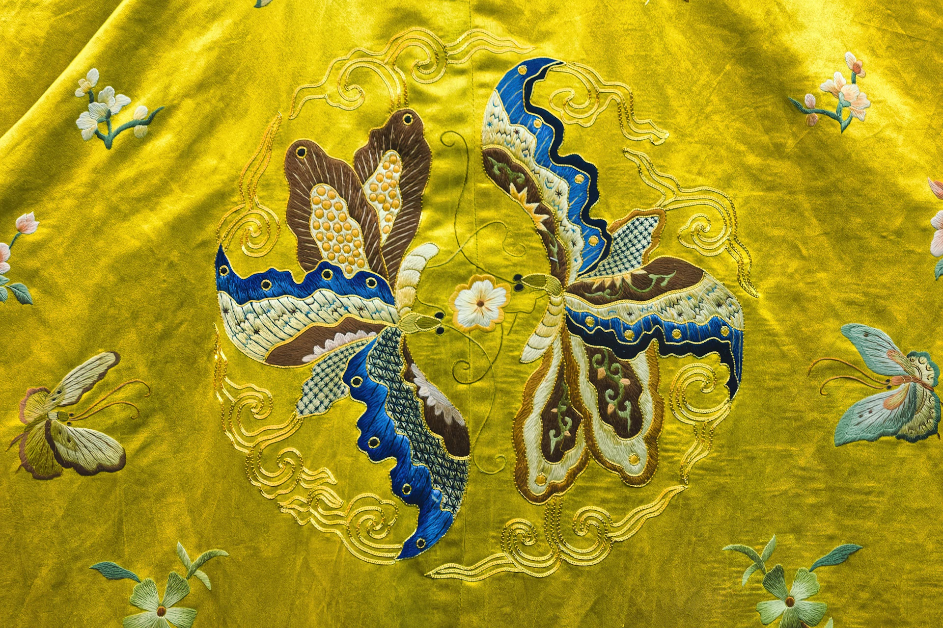Macro of silk embroidery with gold and blue threads