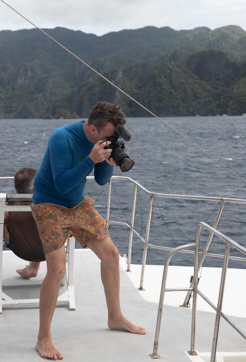 Creator filming with a camera aboard a boat