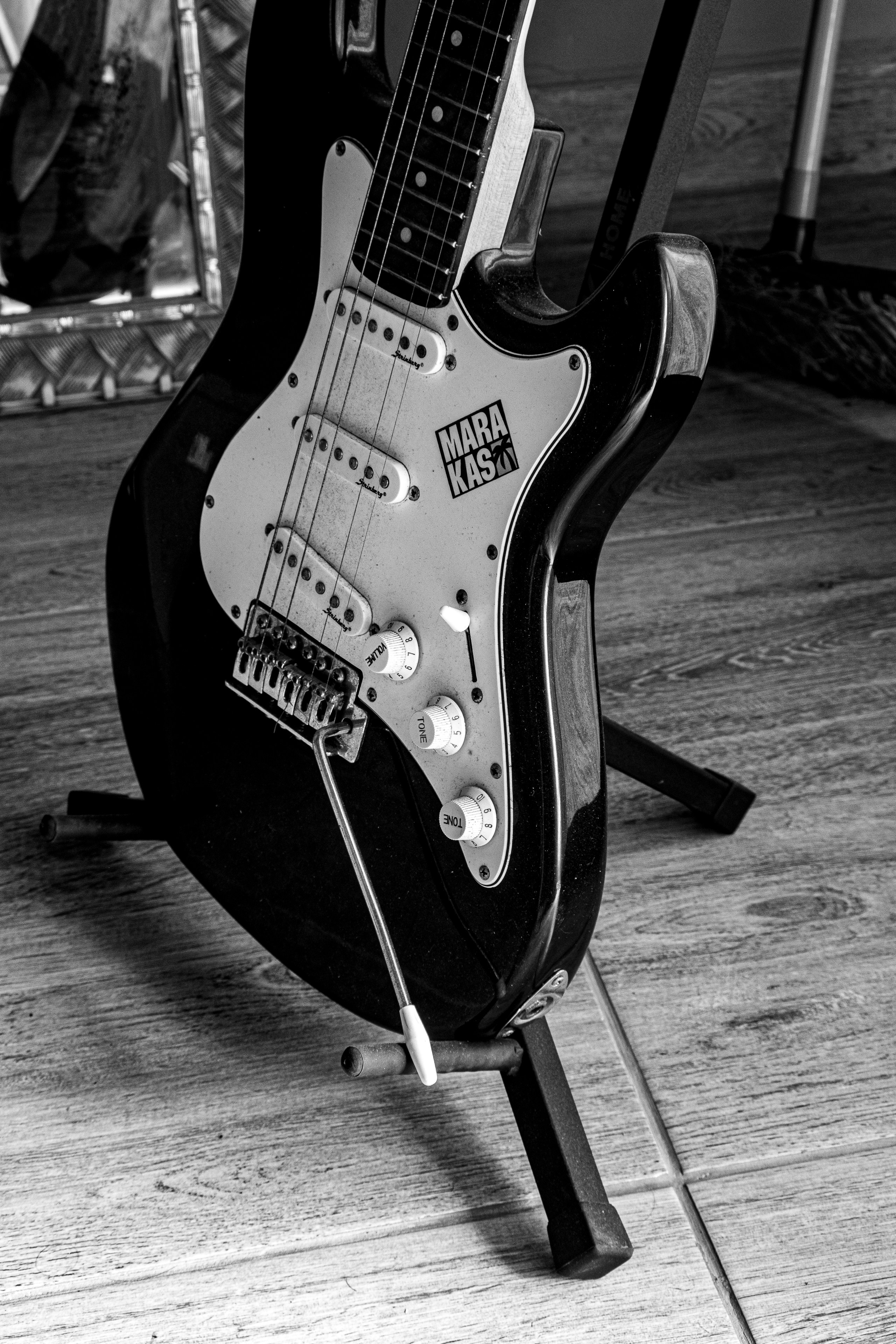Black electric guitar on a stand