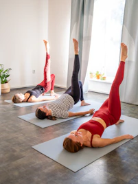Three women doing bridge pose yoga