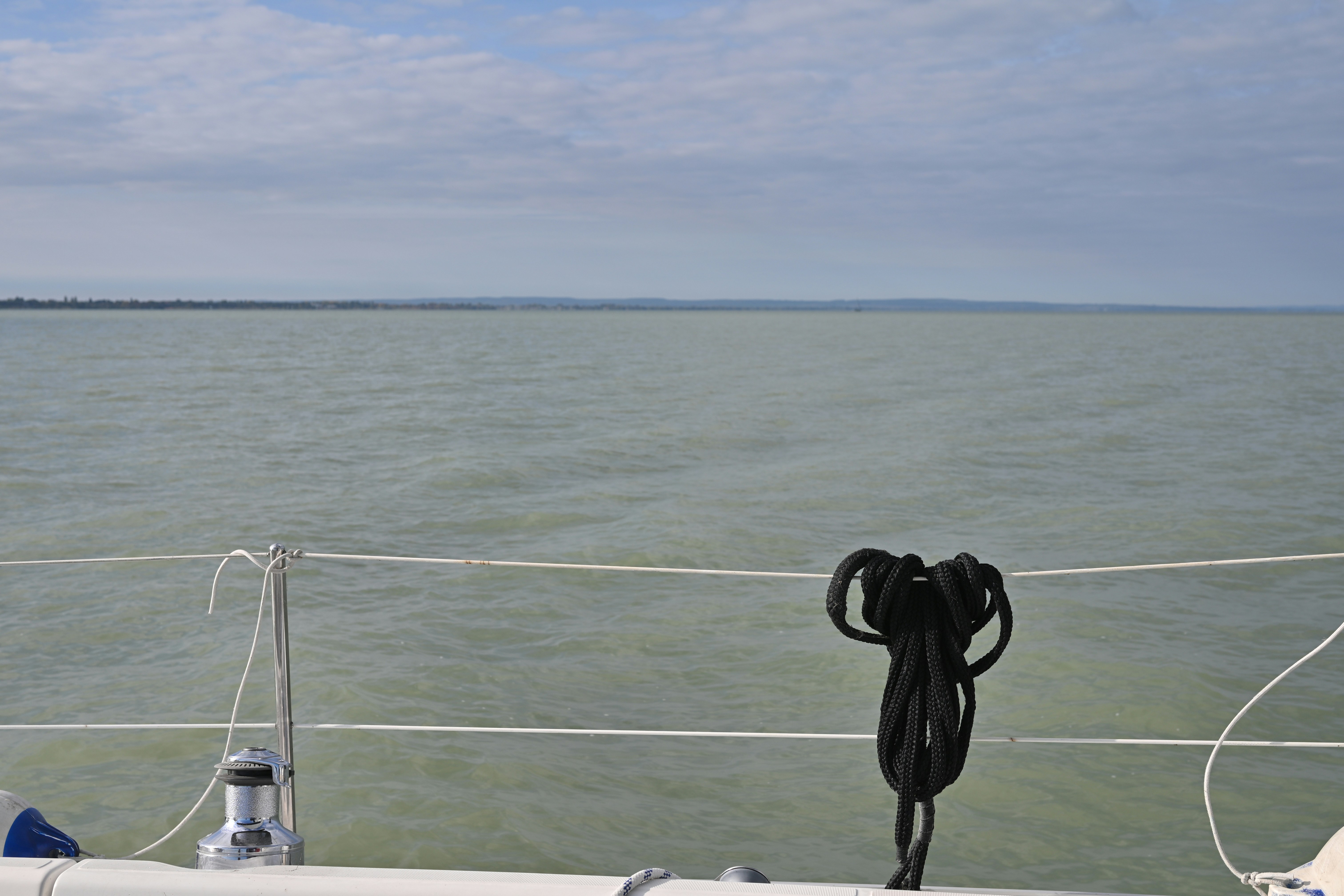 Calm water seen from a sailboat deck