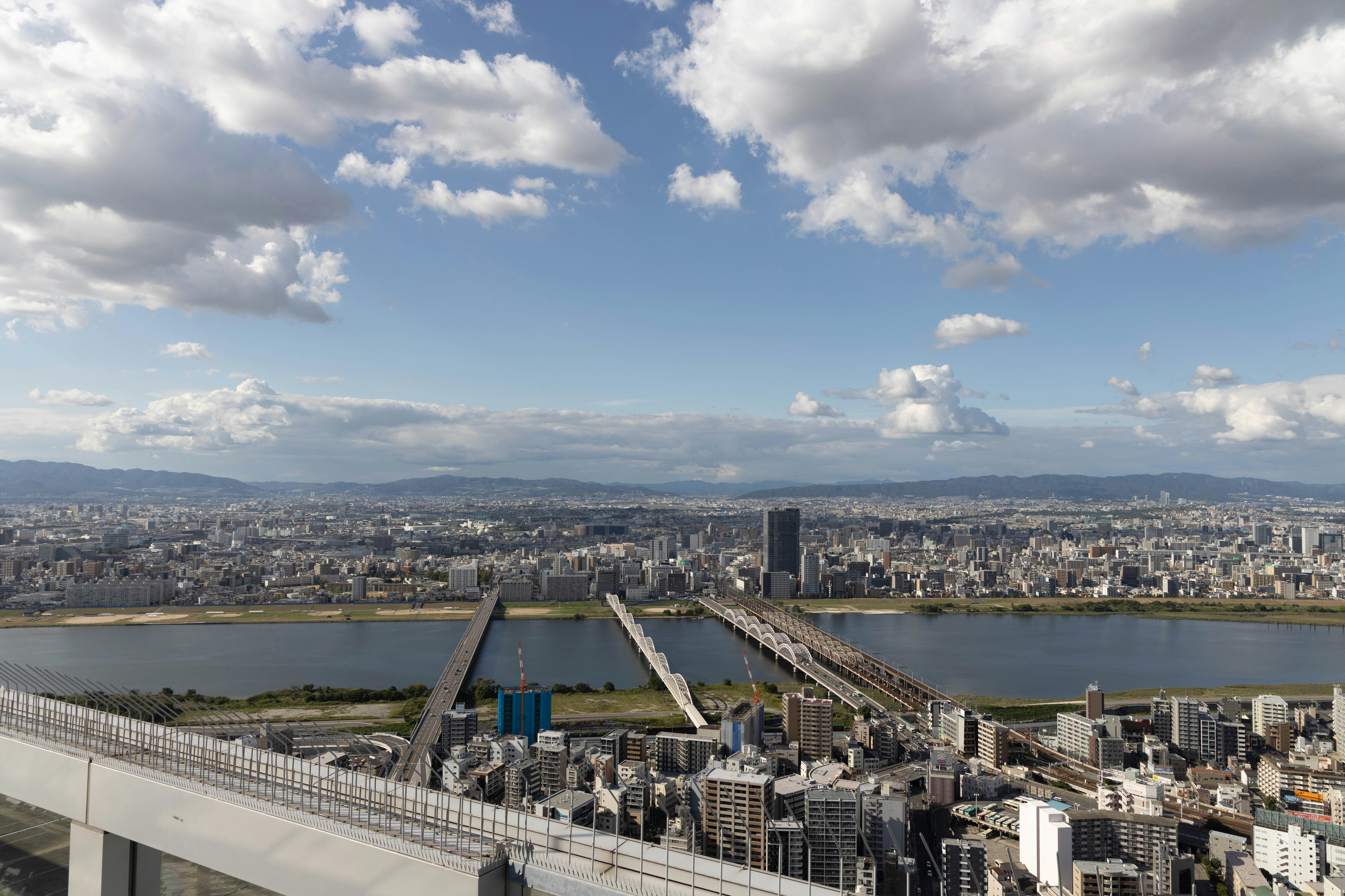 Cityscape with river and bridges under cloudy sky