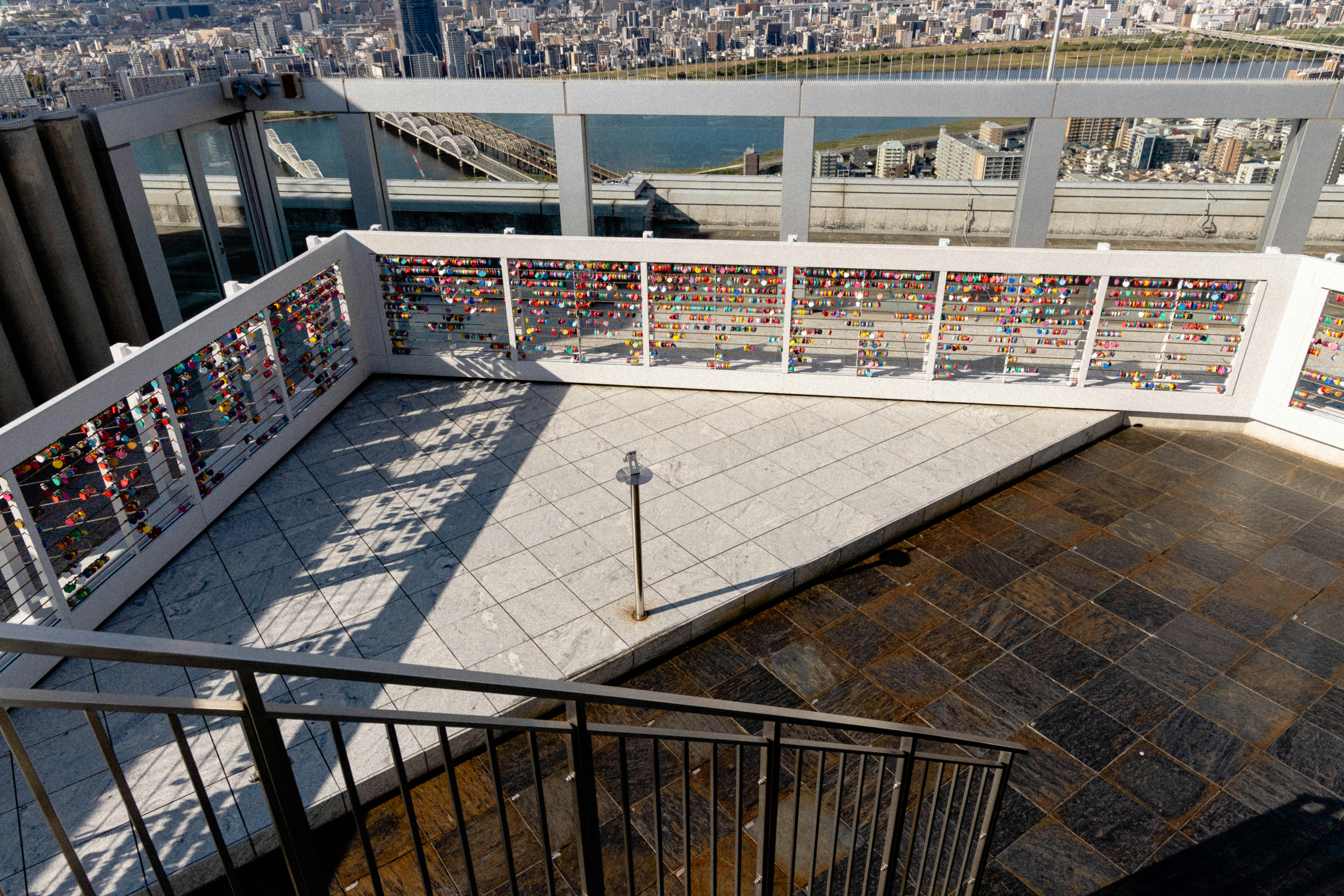 Balcony with locks overlooking a city skyline