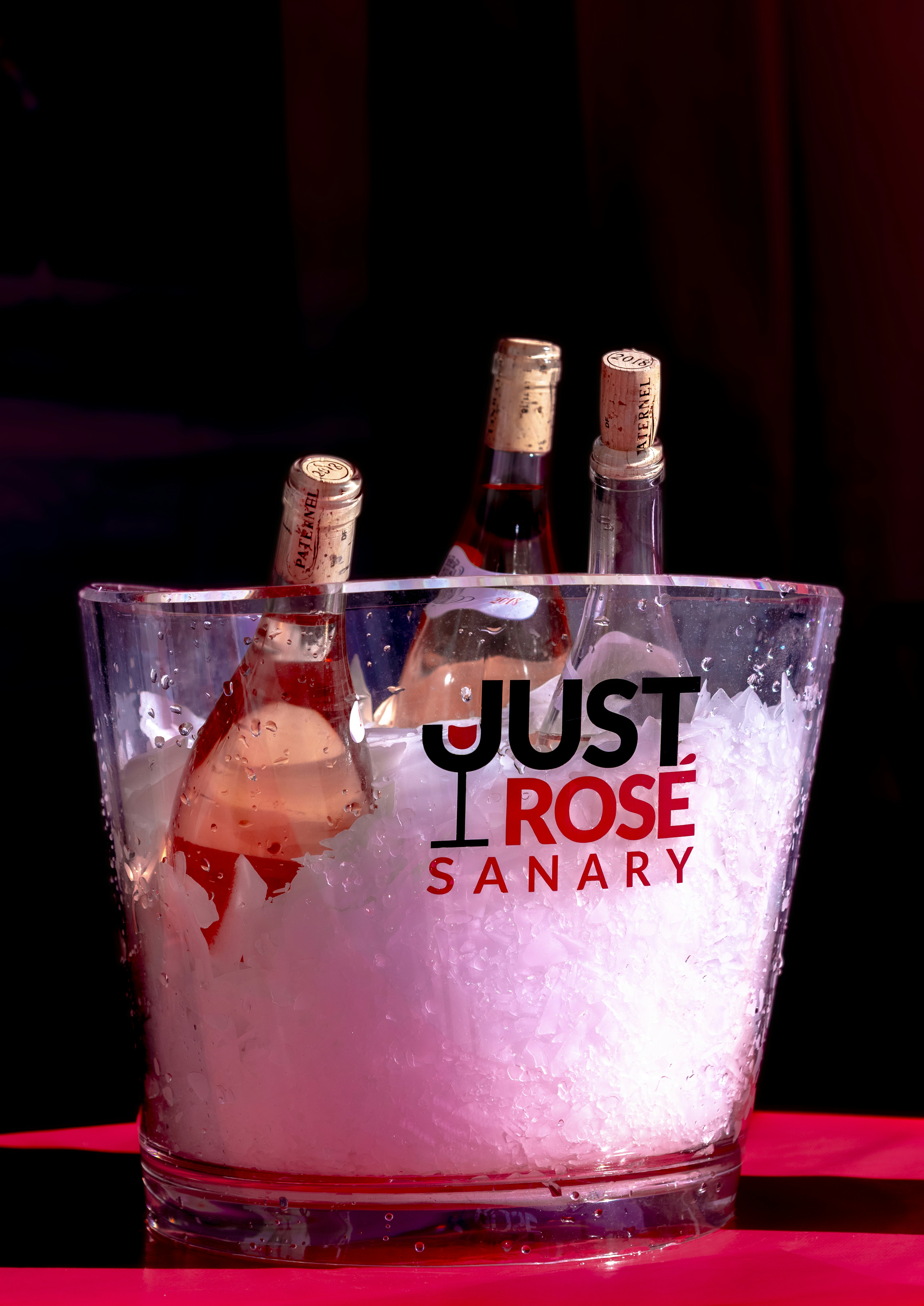 Three bottles of rose wine in ice bucket