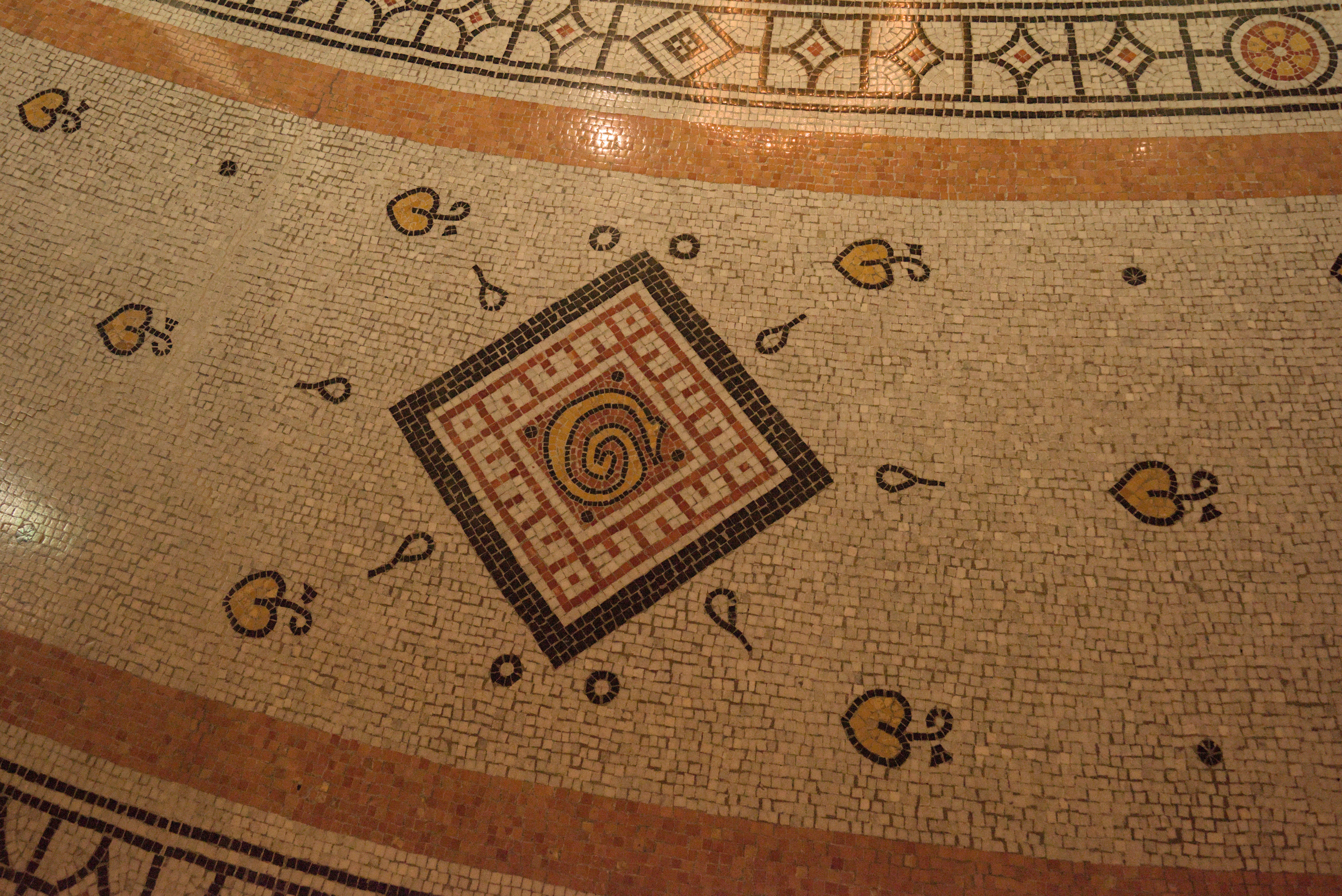 Close-up of a mosaic floor with geometric patterns.