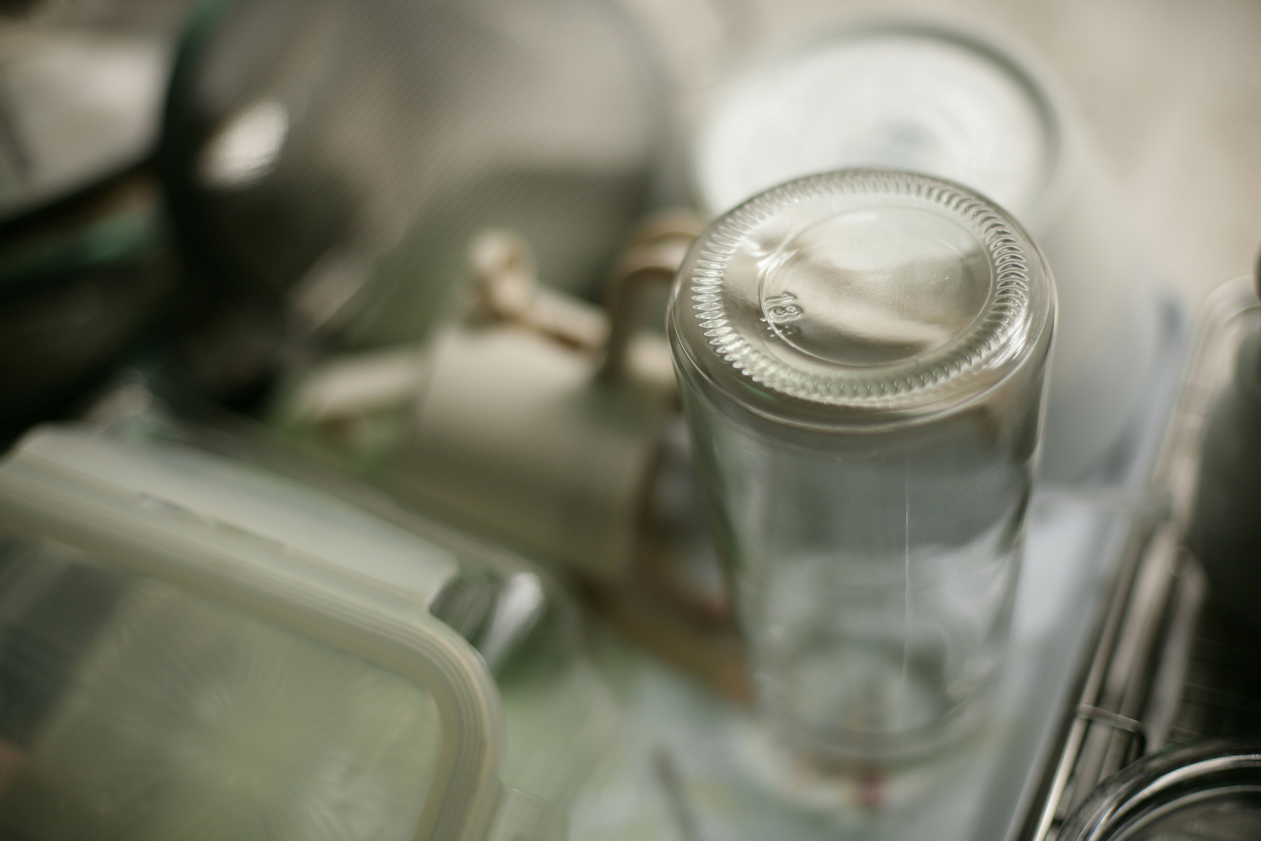 Close-up of an empty glass bottle on a shelf.