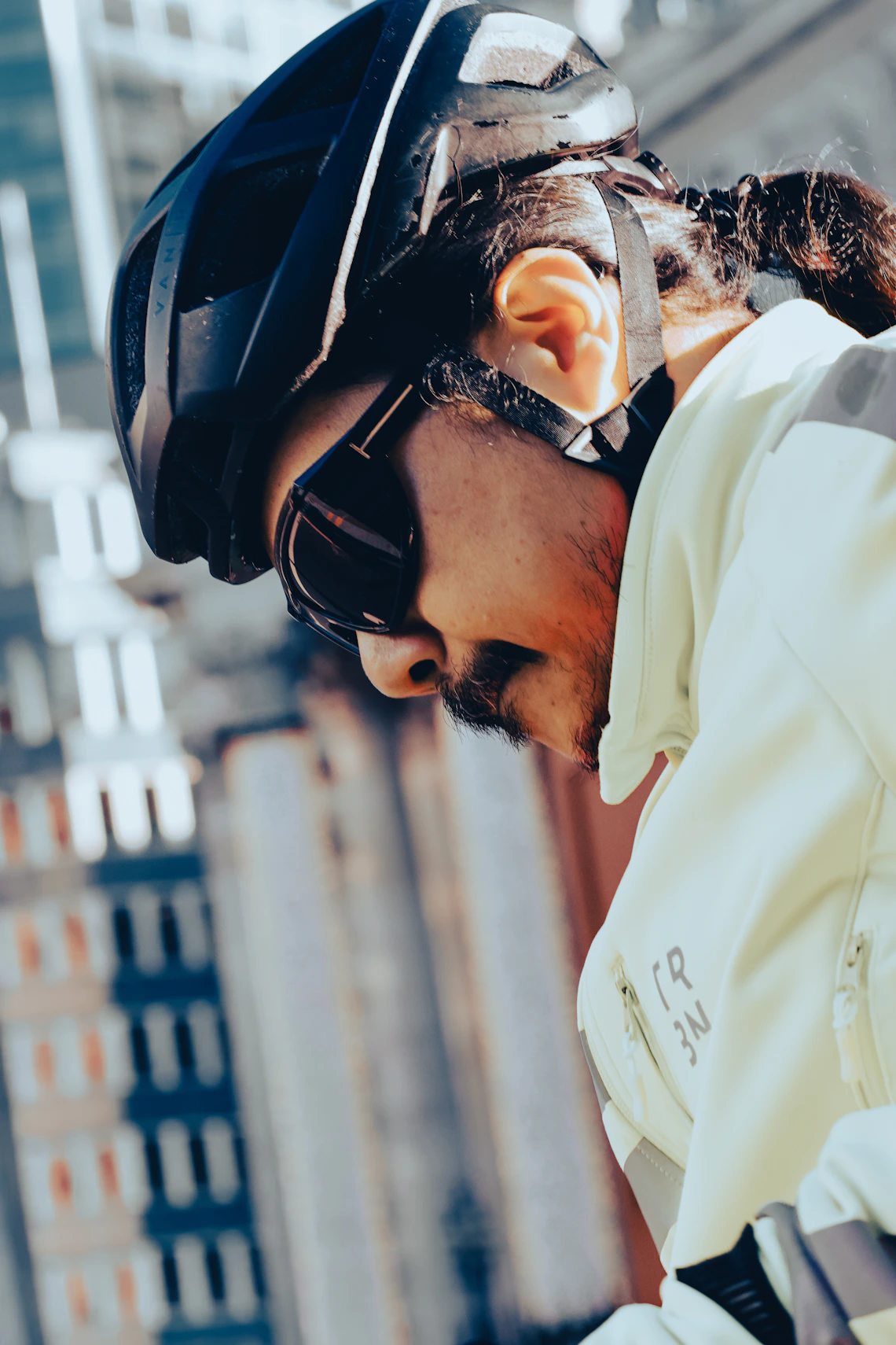 Cyclist wearing a protective helmet in an urban setting