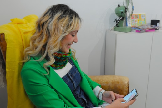 Woman smiling while looking at her phone.