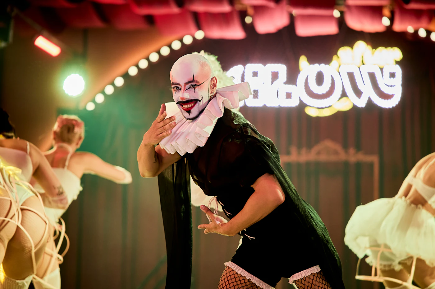 Burlesque performer in elaborate costume on stage