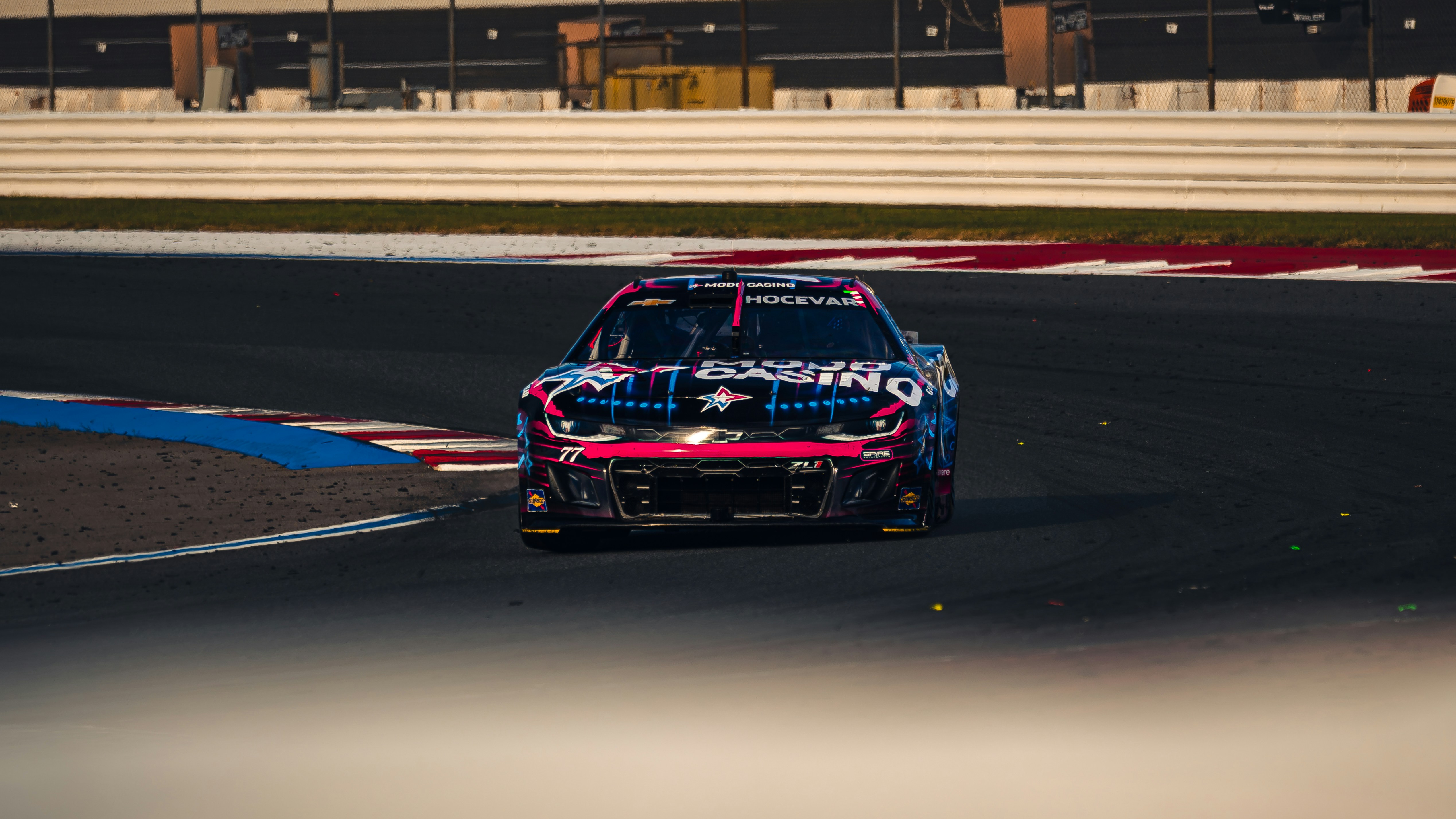 Race car speeds around a track