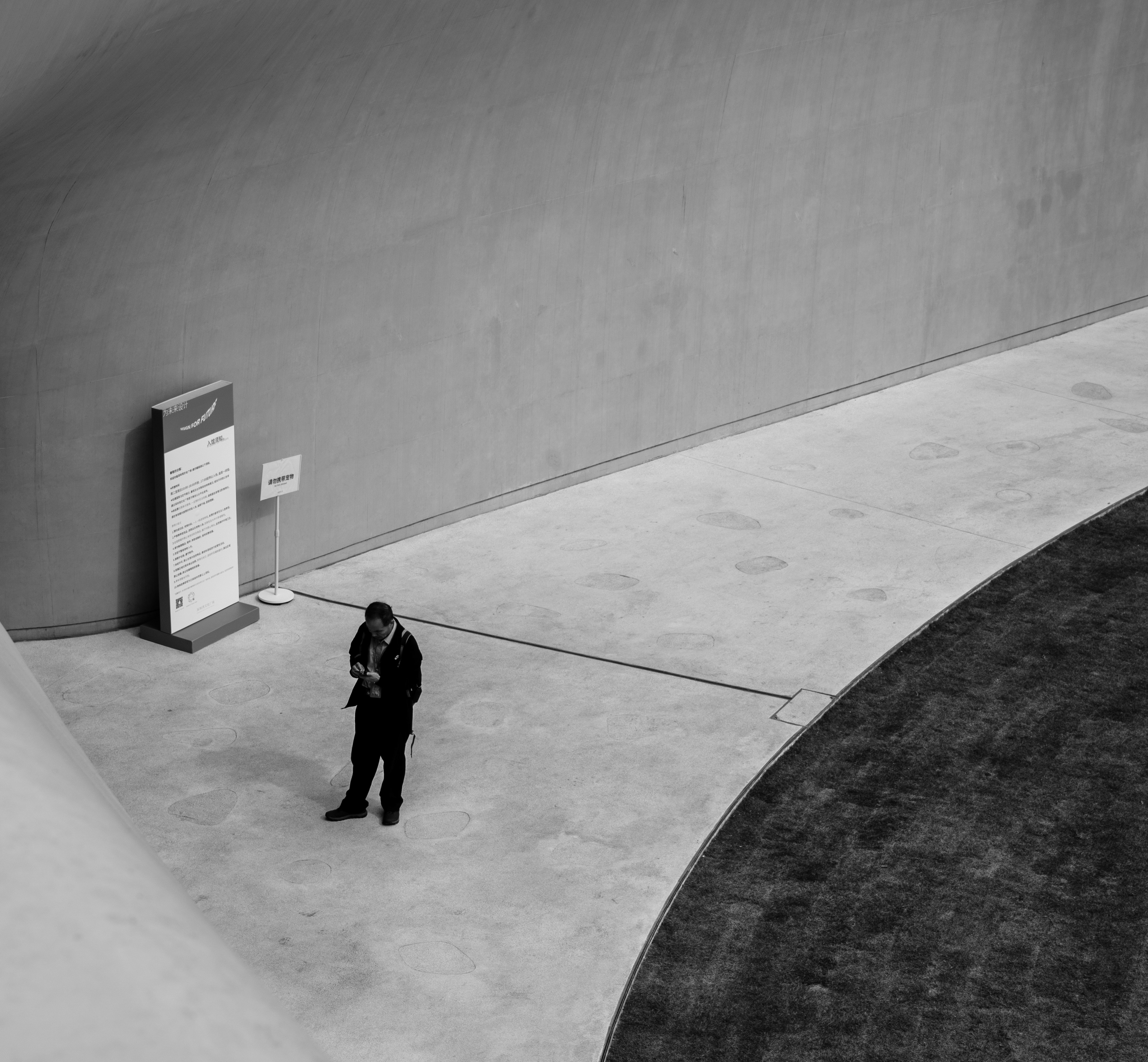 Man standing alone in a modern architectural space.