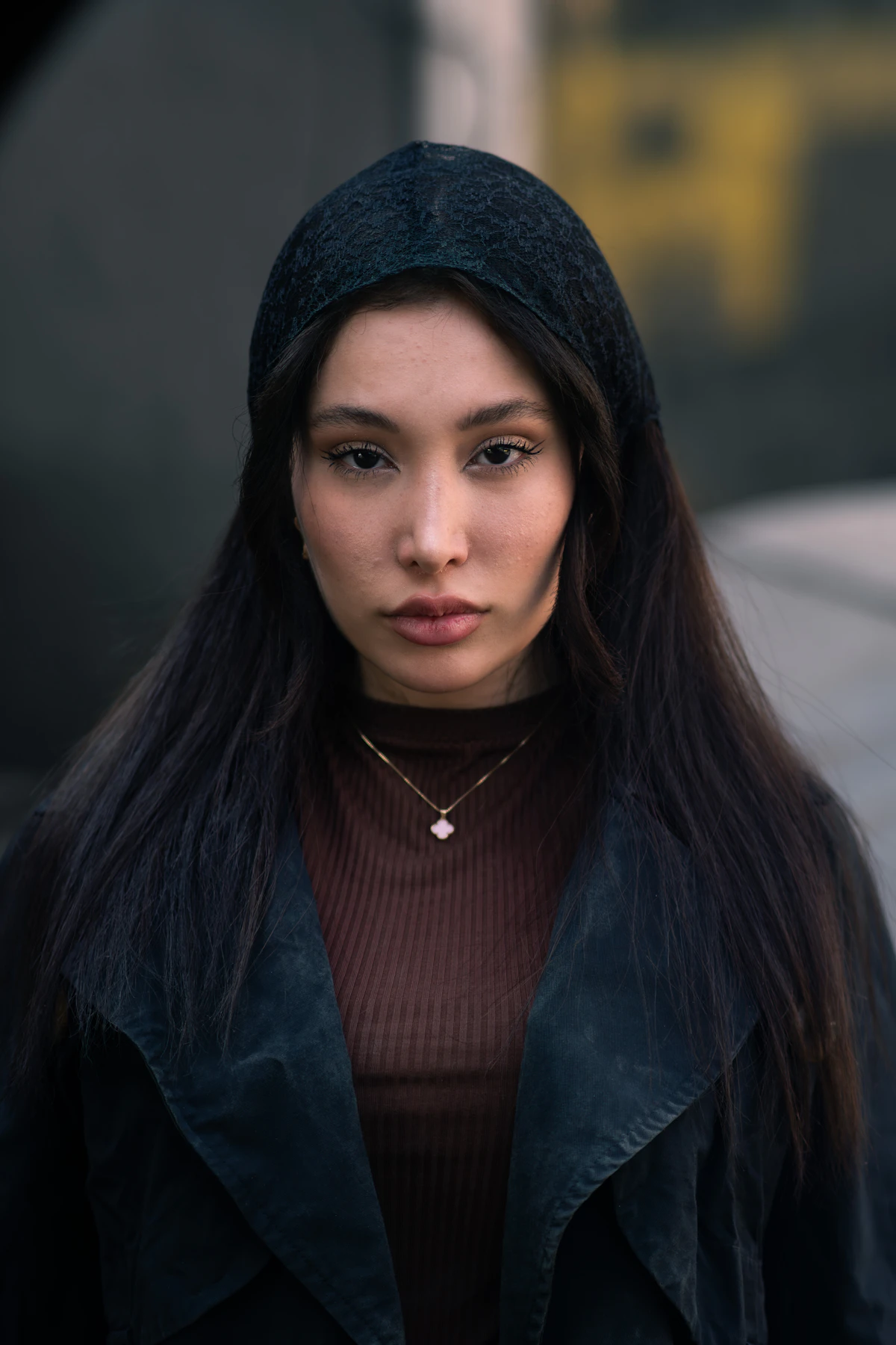 Elegant portrait of a woman wearing a fine silk headscarf and necklace