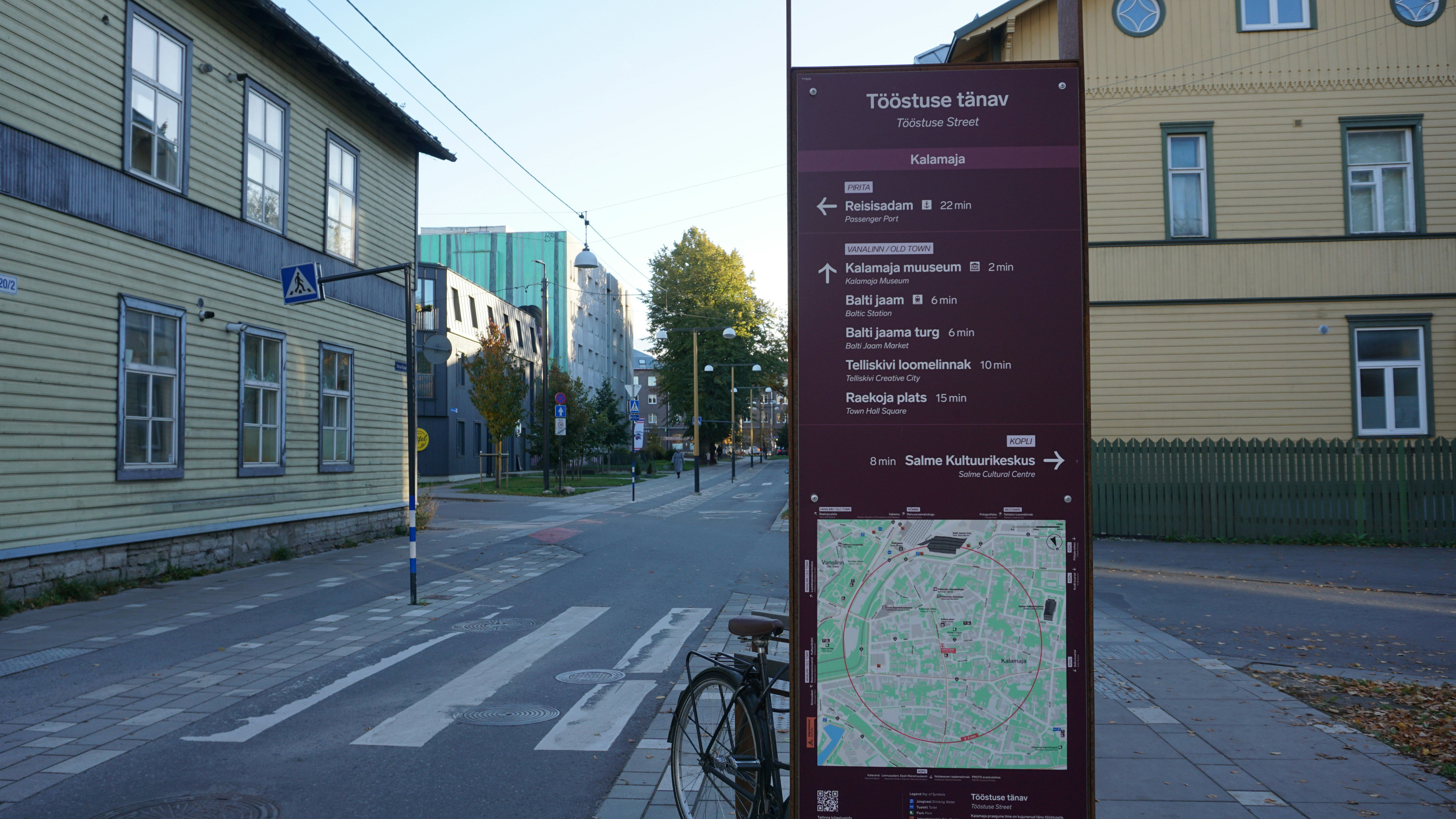 Street sign with map and directions in a city.