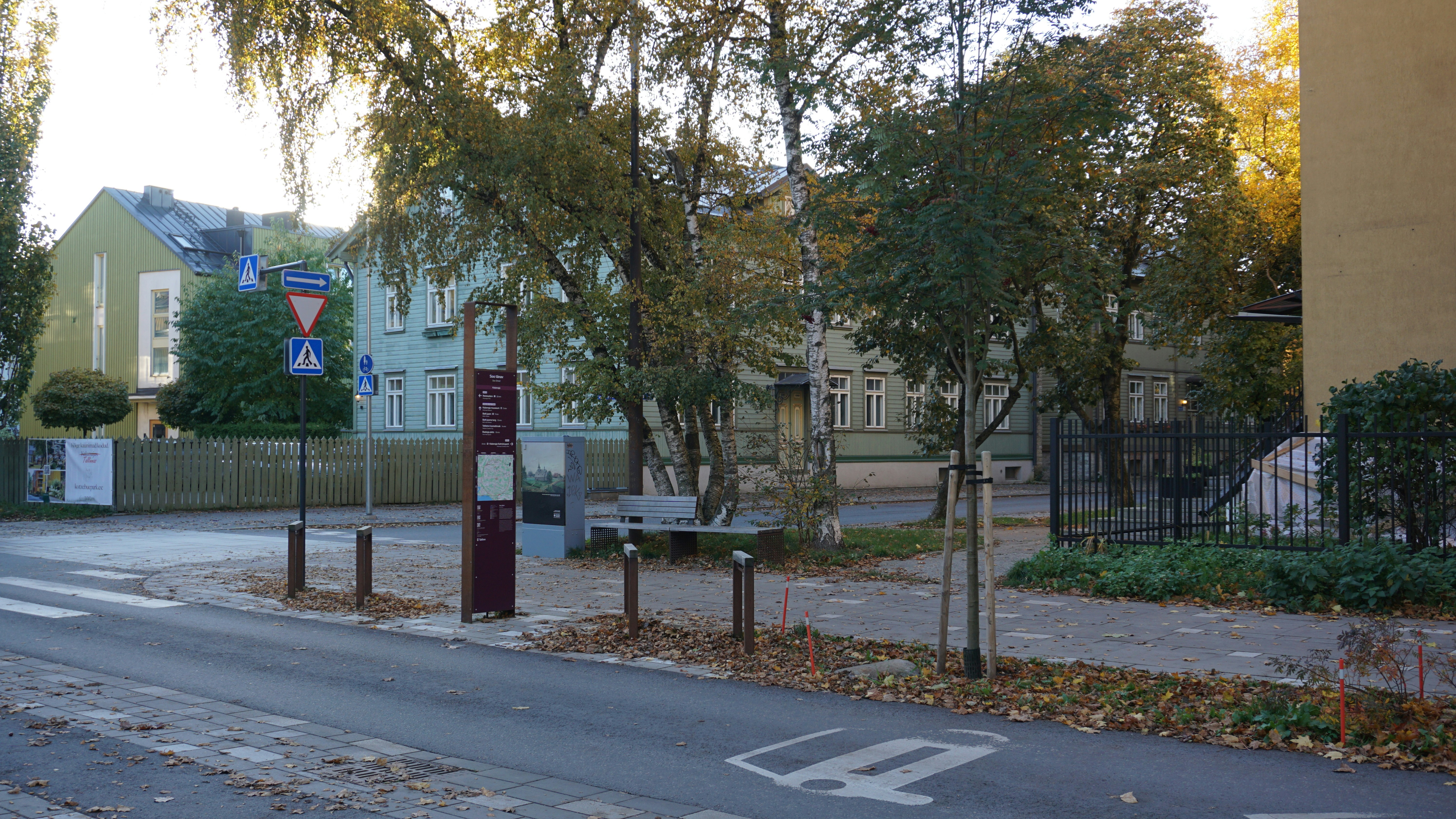 Bus stop with trees and buildings in autumn