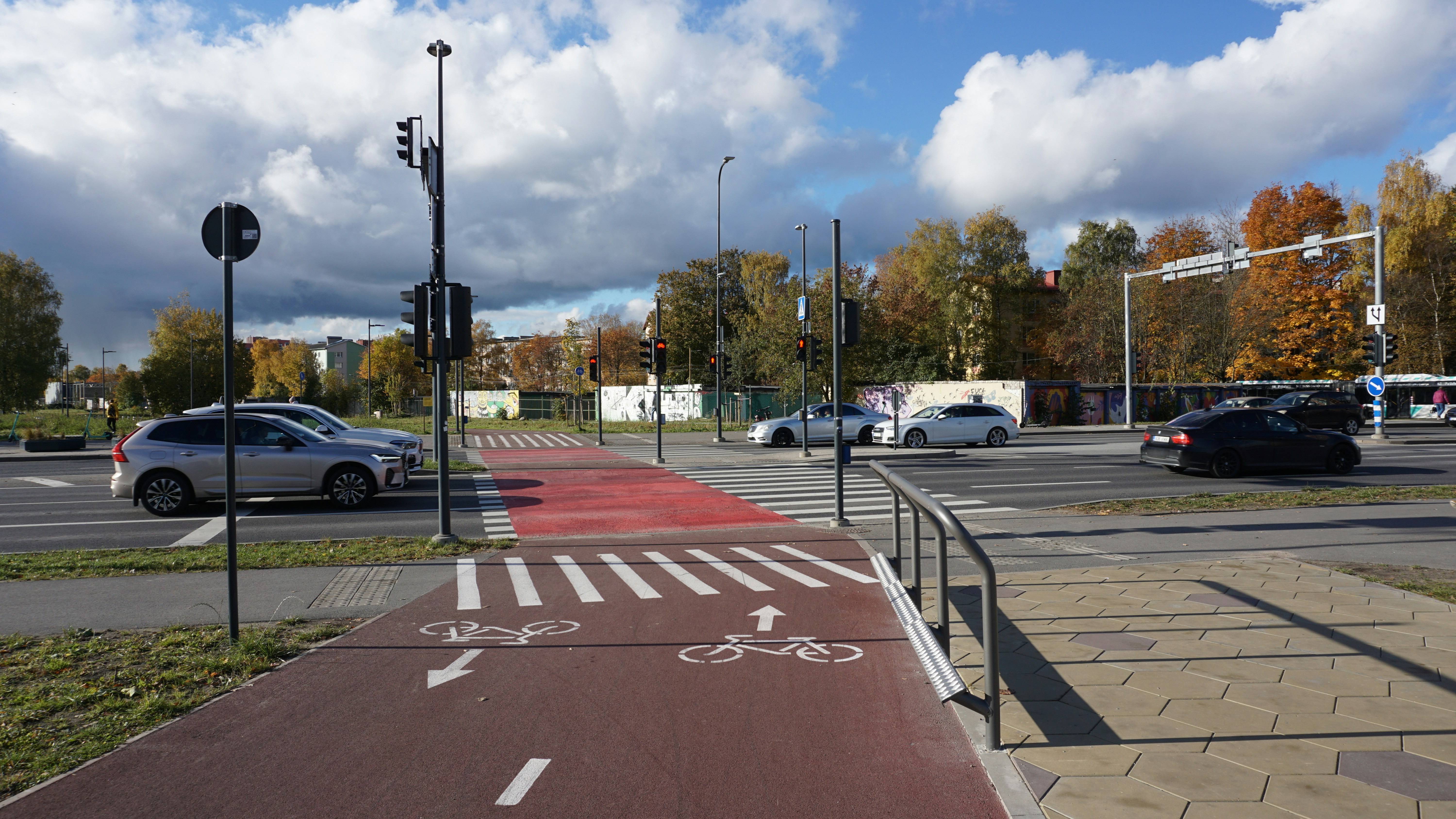 Red bike lane with white markings at intersection