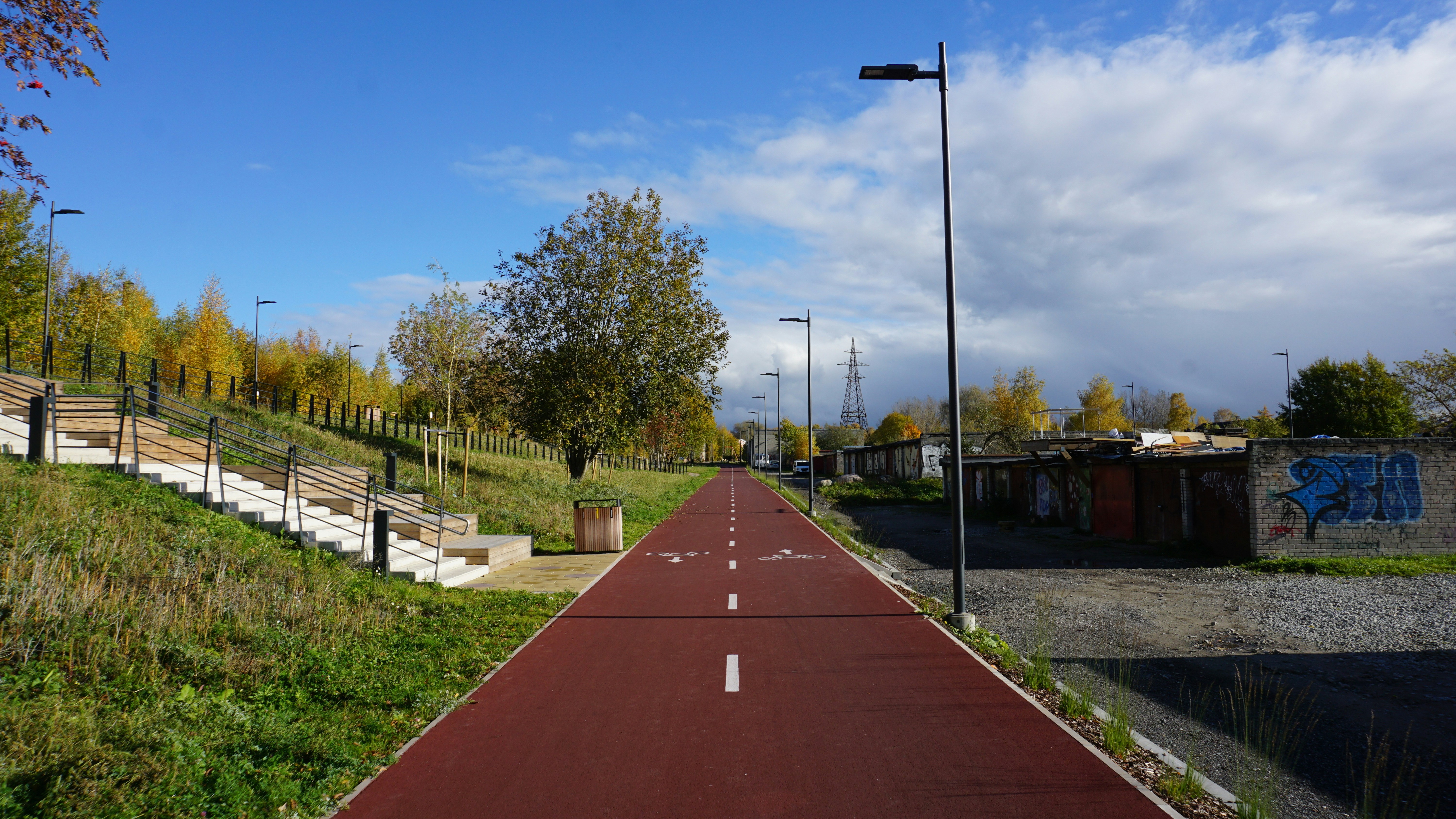 Red bike path with streetlights and trees