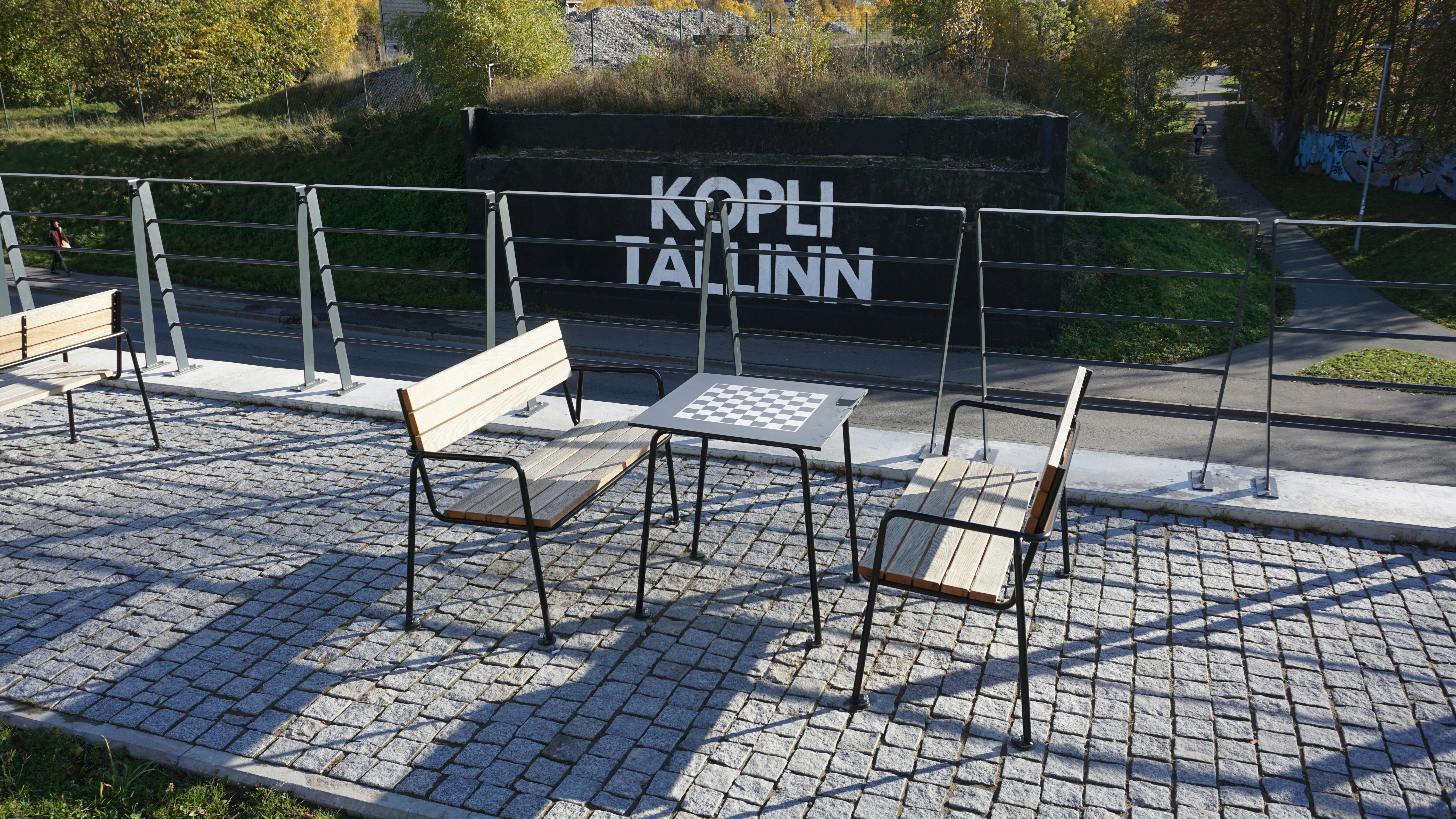 Outdoor seating area with "kopli tallinn" sign