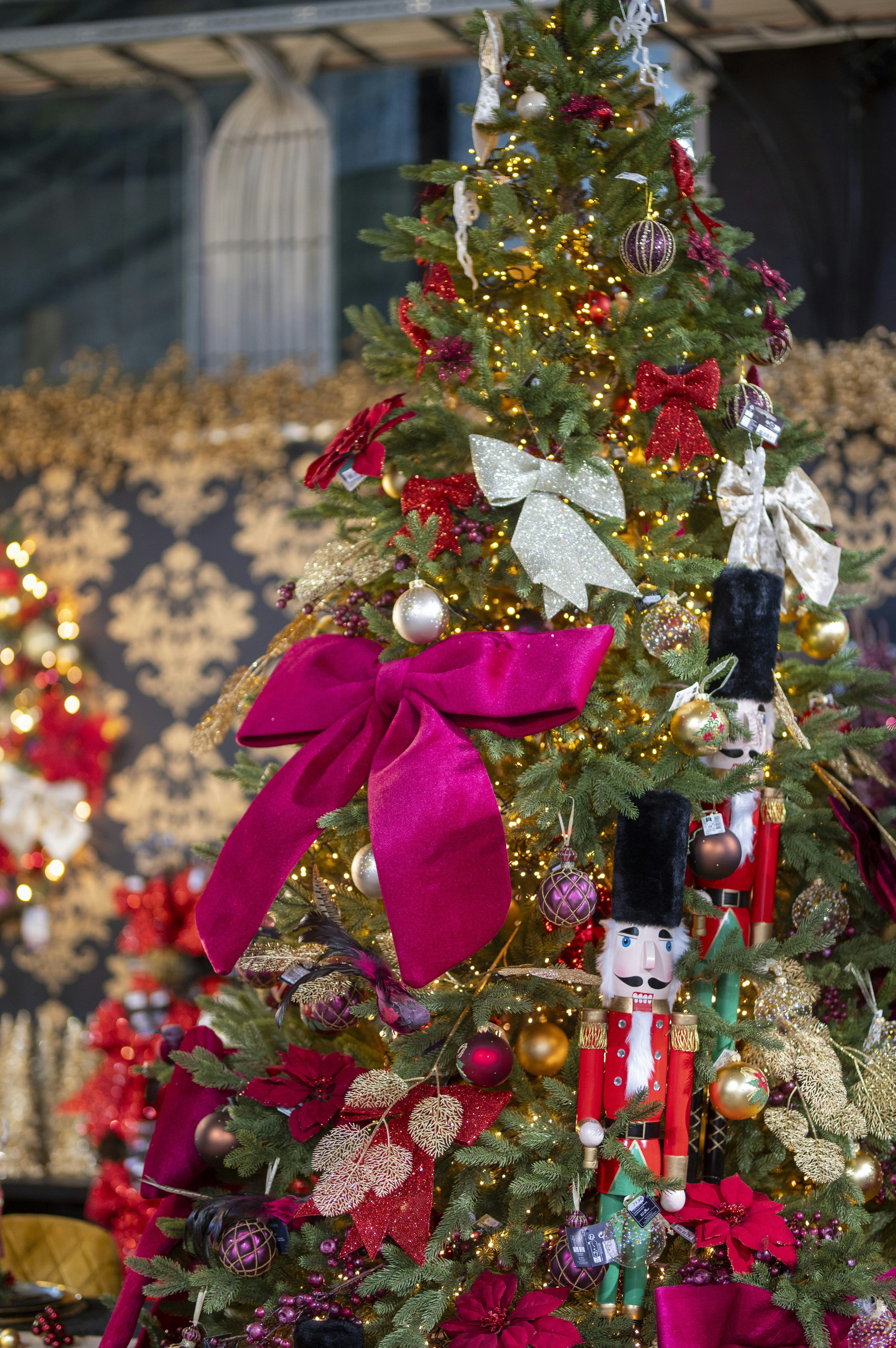 A decorated christmas tree with nutcrackers and bows.