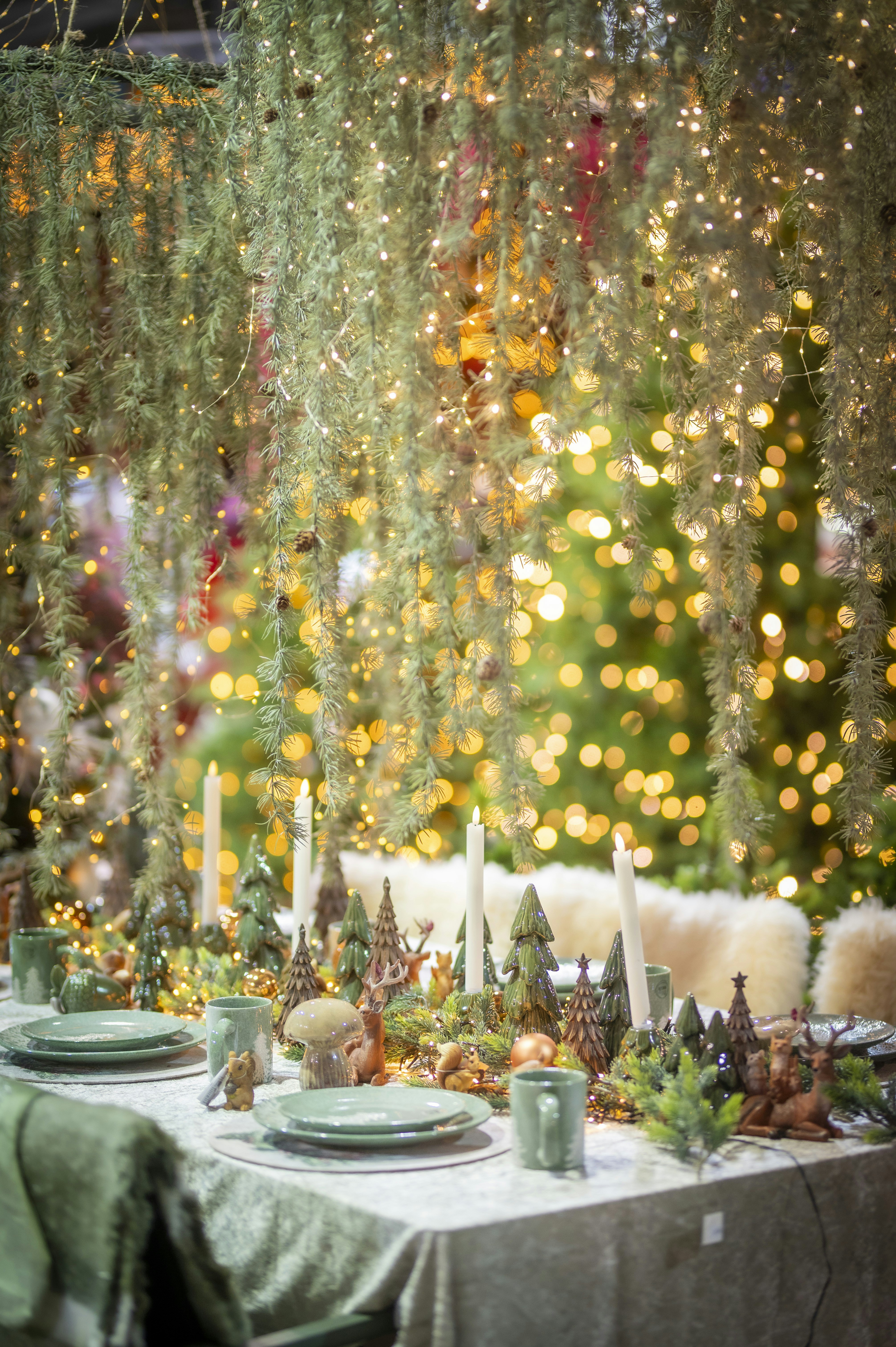 Festive table setting with christmas trees and lights