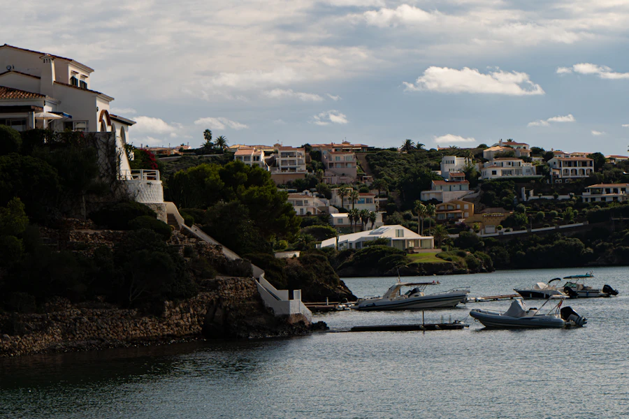 Mediterranean coastal town of white villas above a sheltered boat harbor