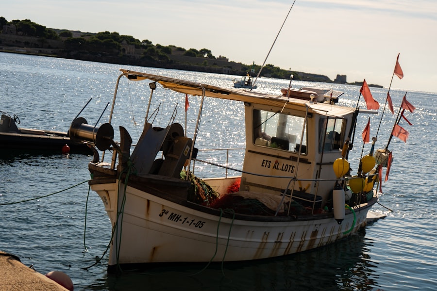 A small wooden fishing boat moored at a harbour dock, the kind of vessel most Caribbean fishers insure informally or not at all