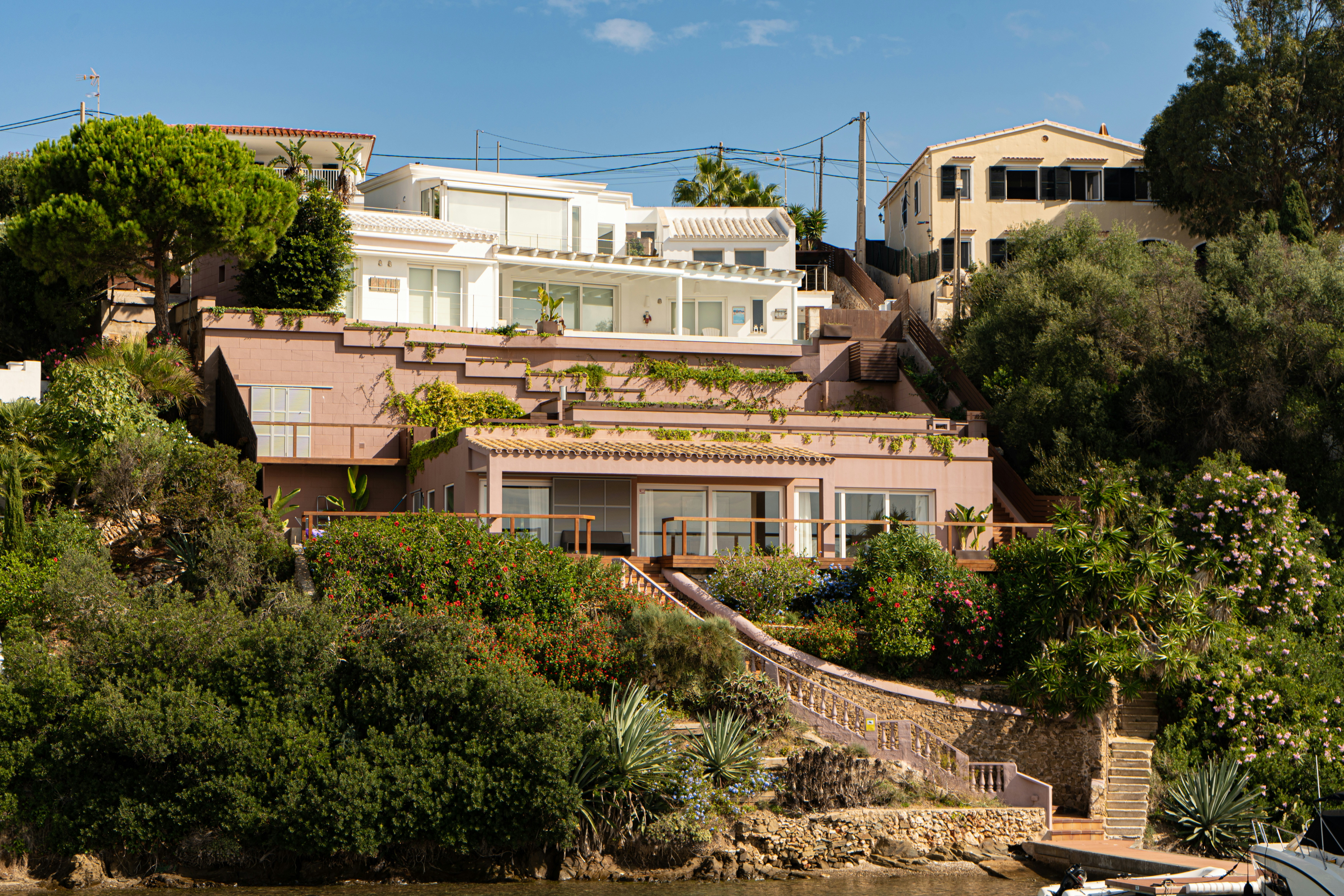 Modern houses nestled on a lush, green hillside.