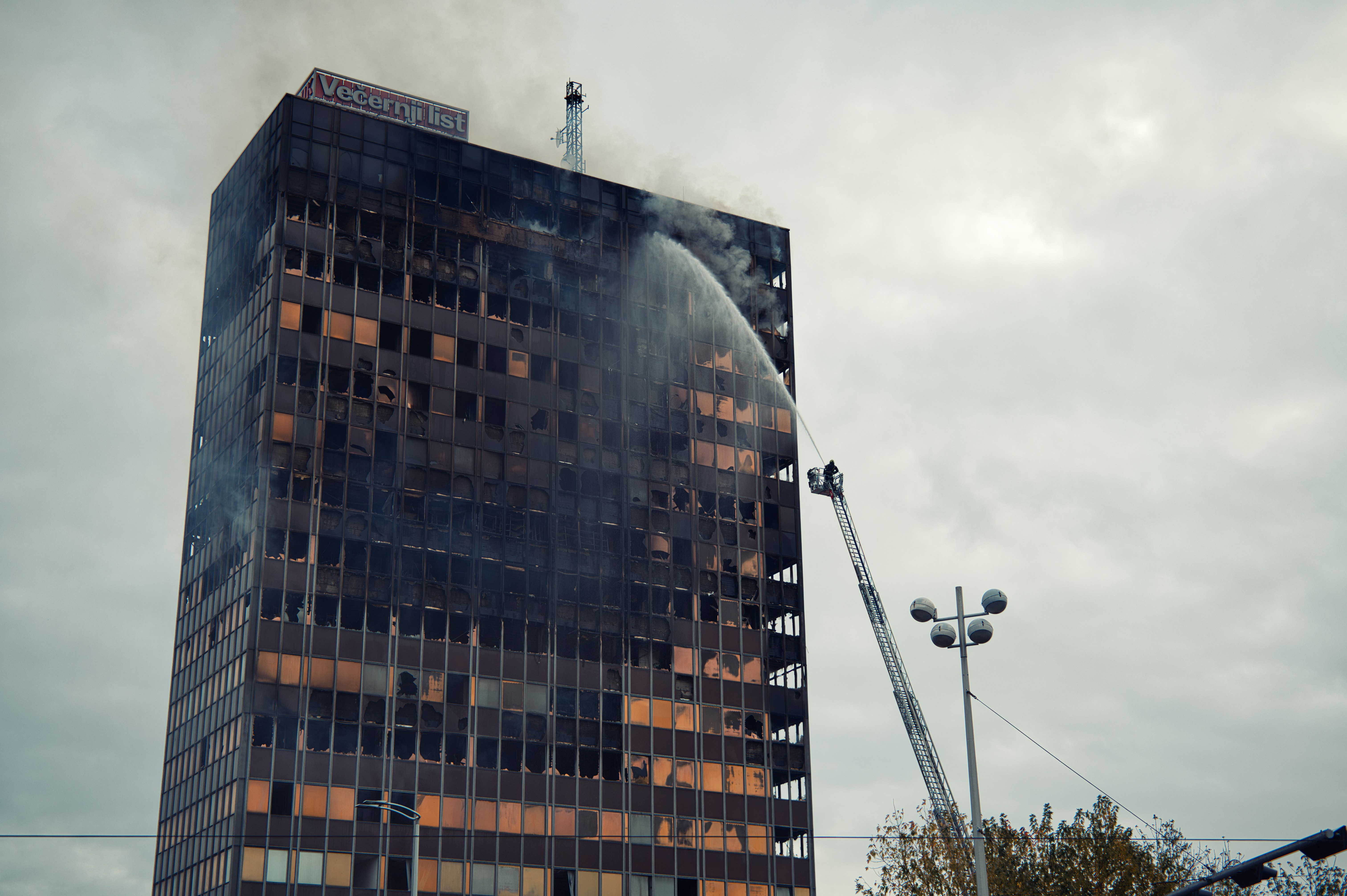 Skyscraper on fire with firefighters battling blaze