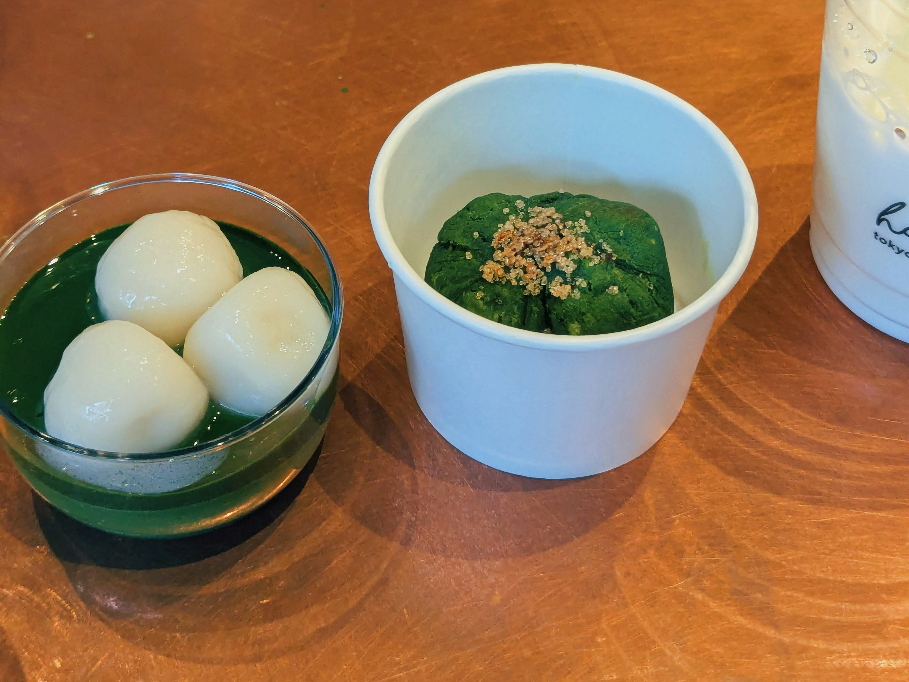 Green dessert with white mochi balls and nuts