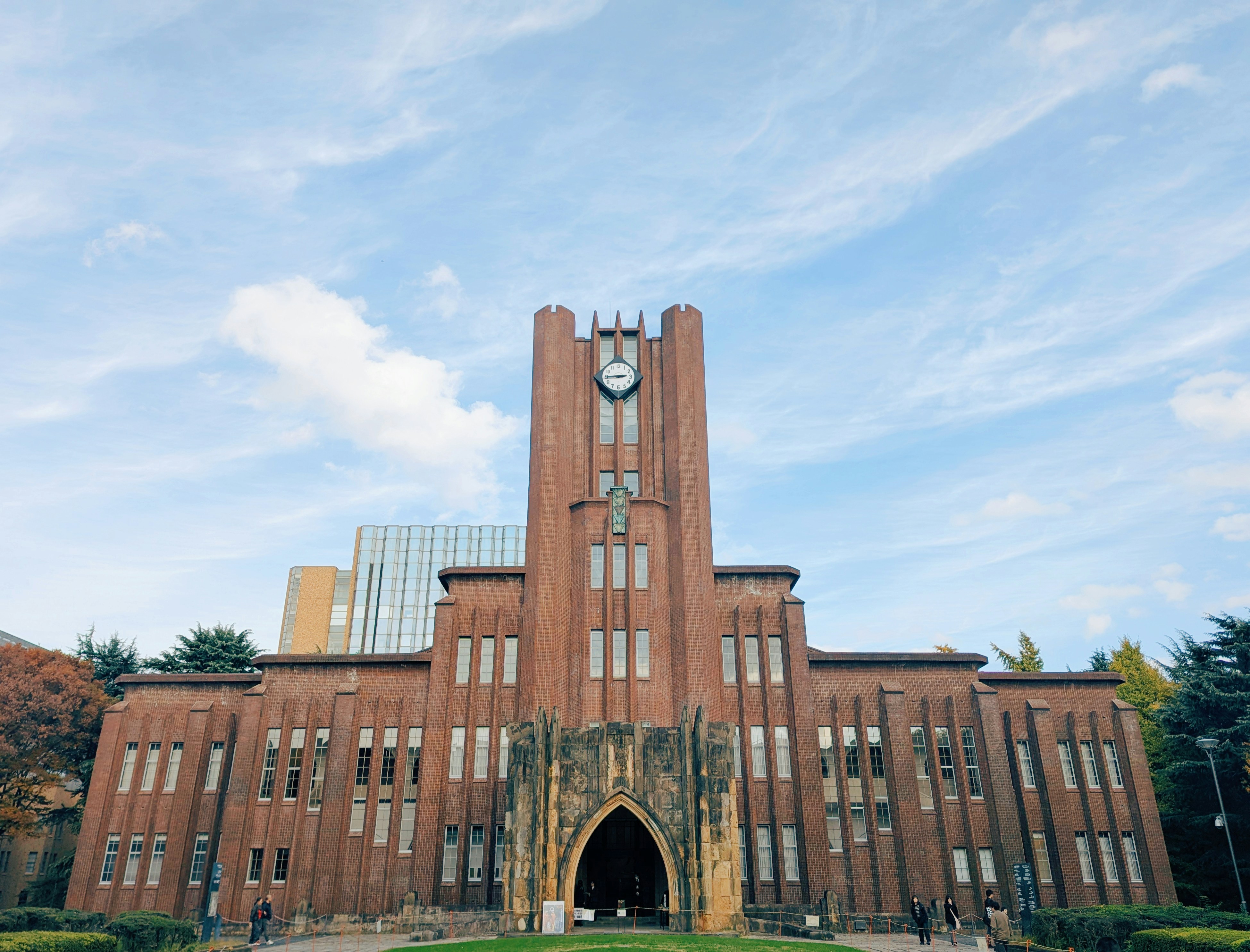 Historic brick building with clock tower under blue sky