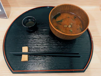 Miso soup with chopsticks and tea on tray