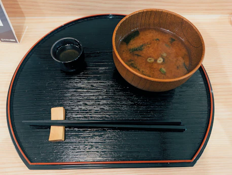 Miso soup with chopsticks and tea on tray