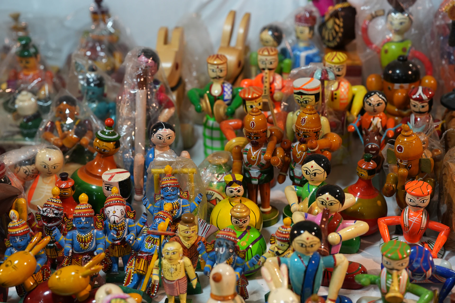 Collection of colorful wooden handmade dolls and toys