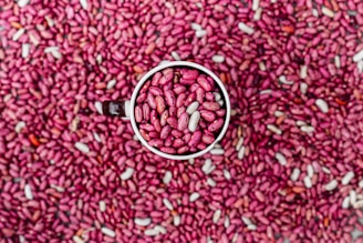 A white cup filled with pink beans