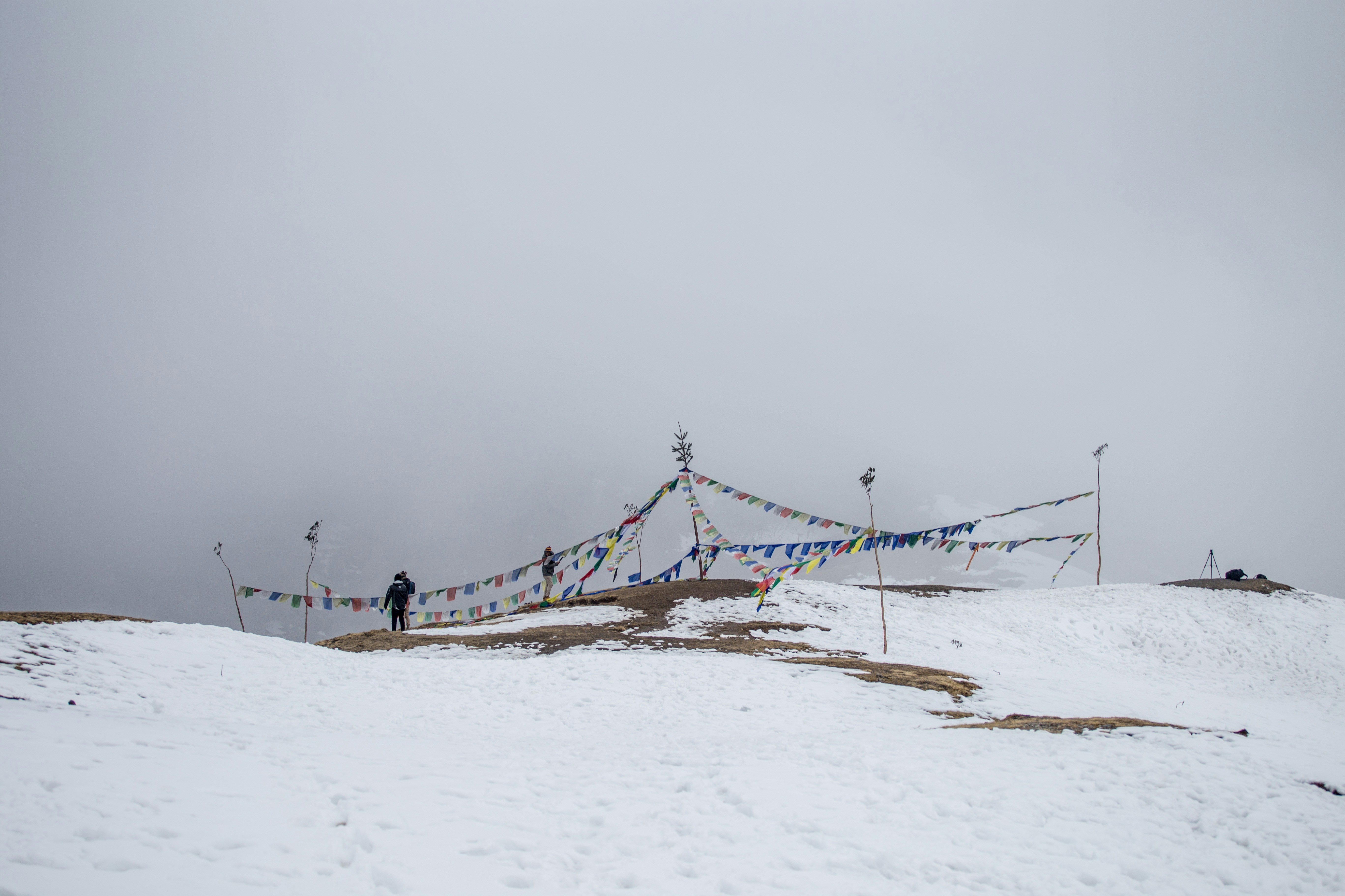Prayer flags on a snowy mountain pass