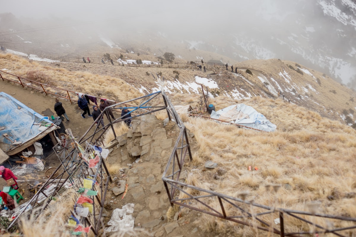 Pilgrims walking a steep rocky mountain trail in the Himalaya