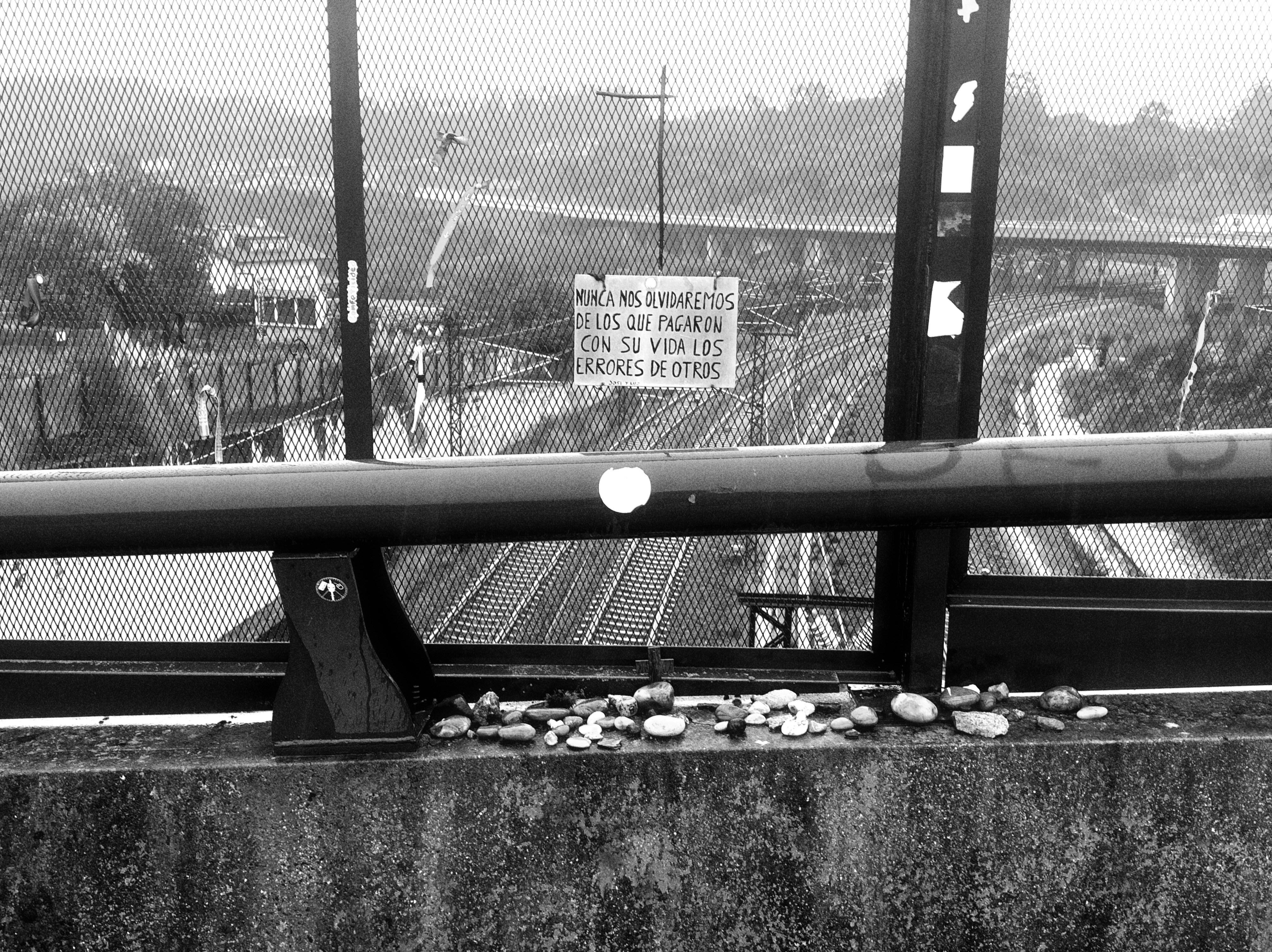 Stones on a railing overlooking train tracks