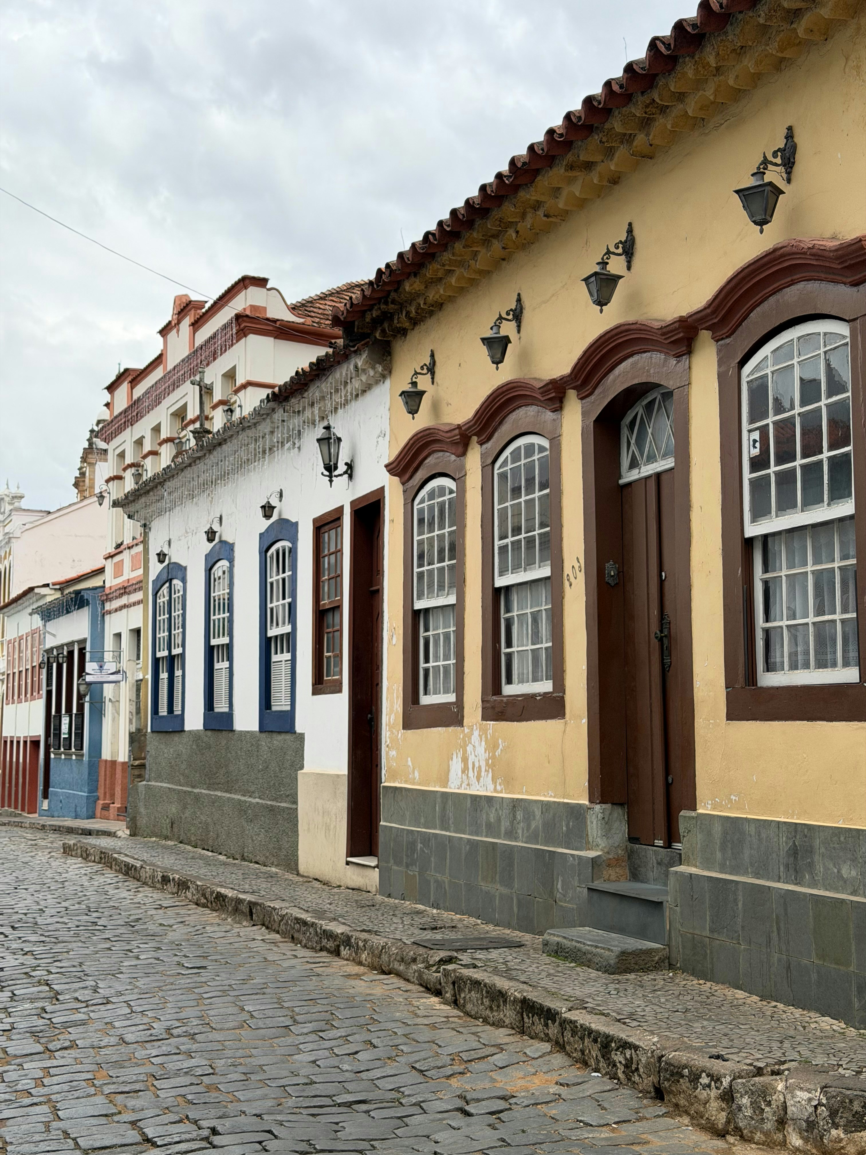Colorful historic buildings line a cobblestone street.