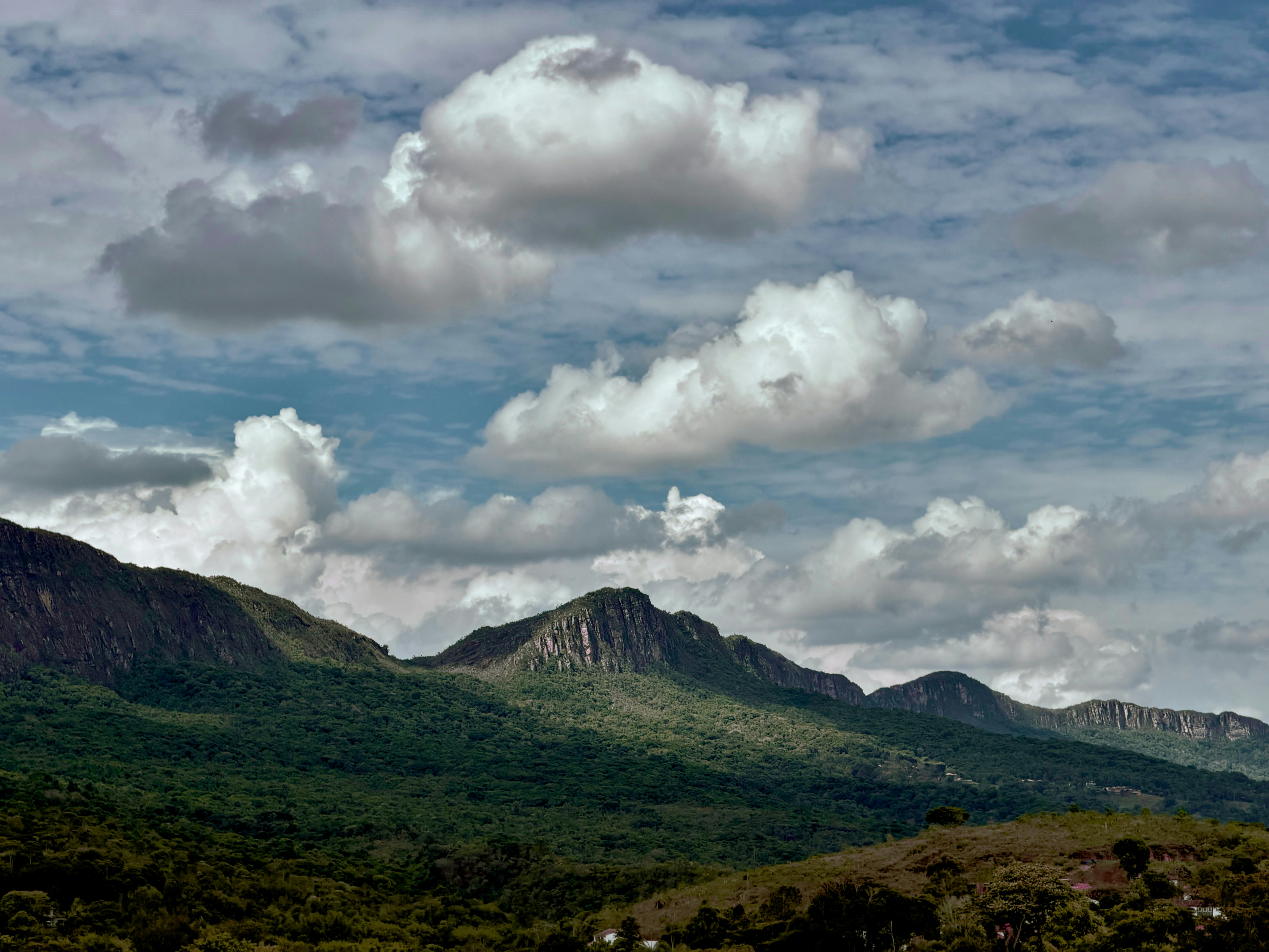 Rolling green hills under a cloudy sky