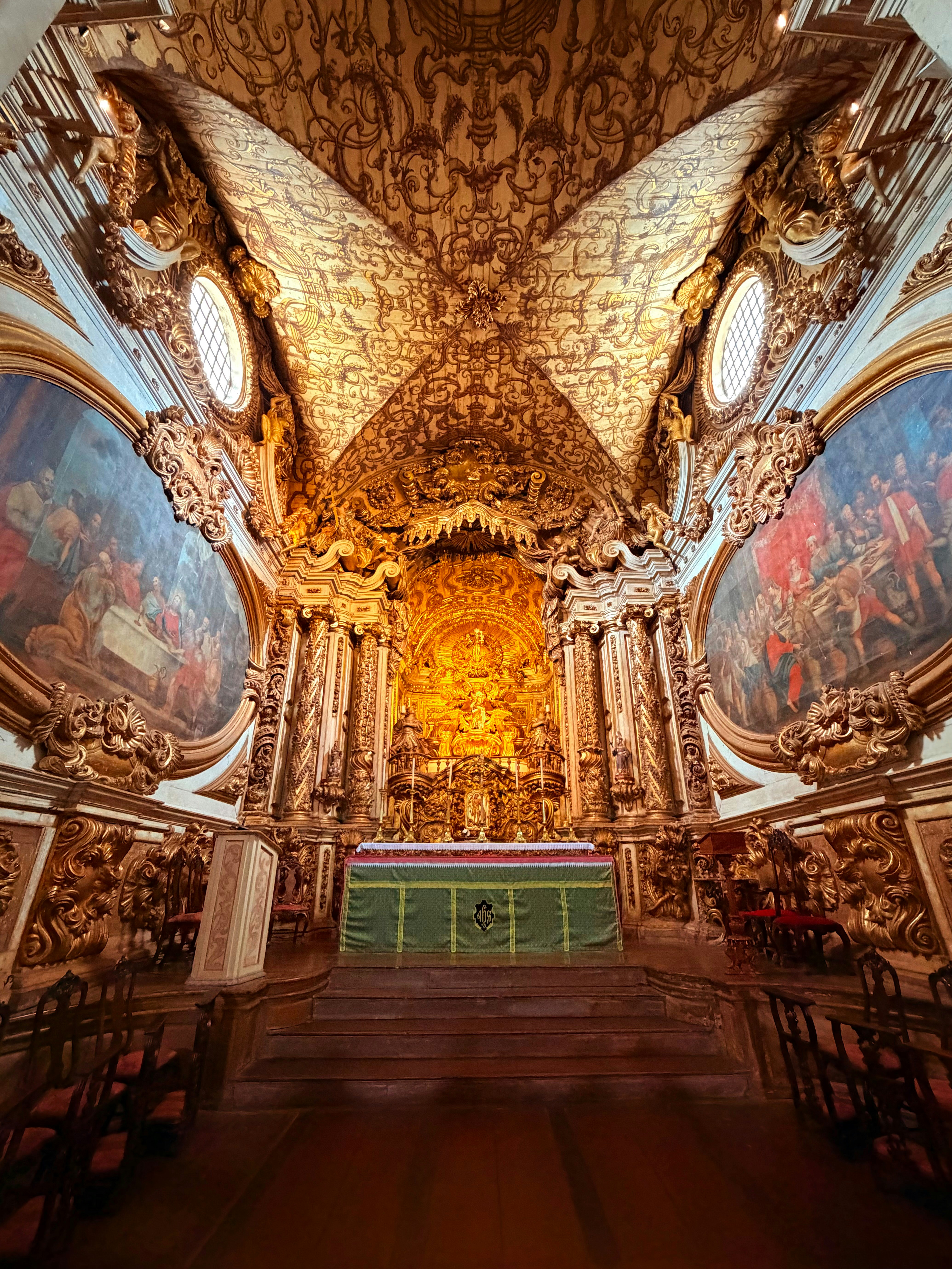 Ornate golden altar in a richly decorated church interior.