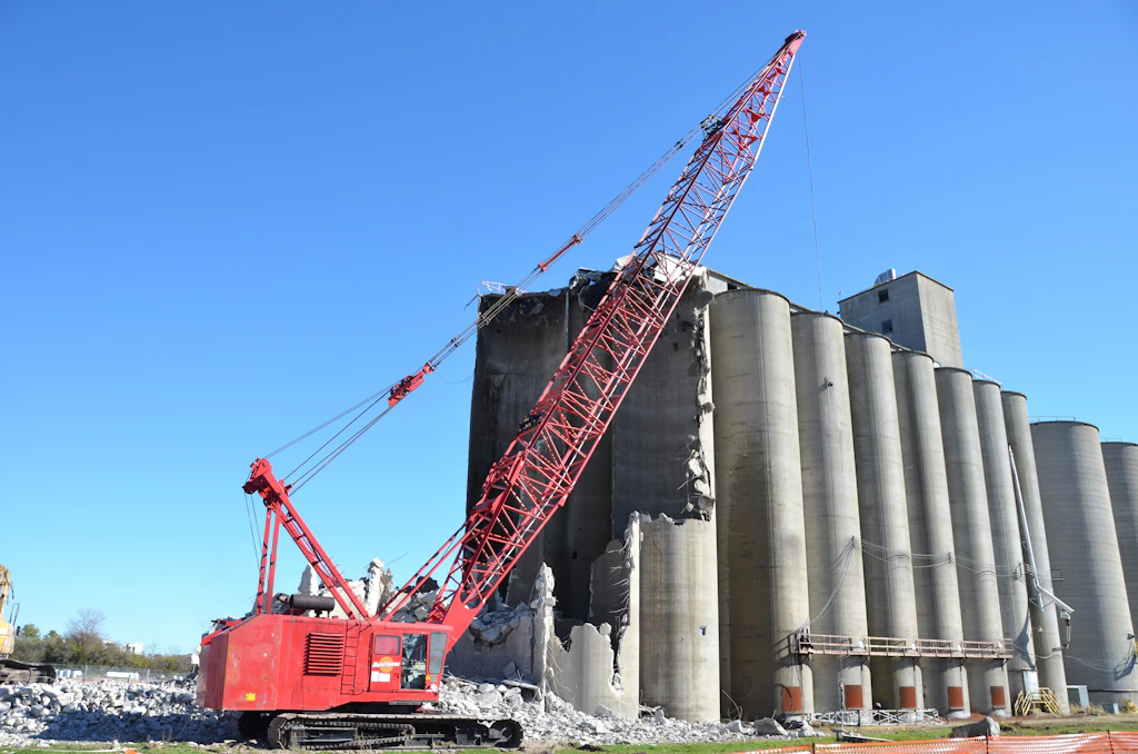 Grapple truck and heavy equipment at a Volusia County job site