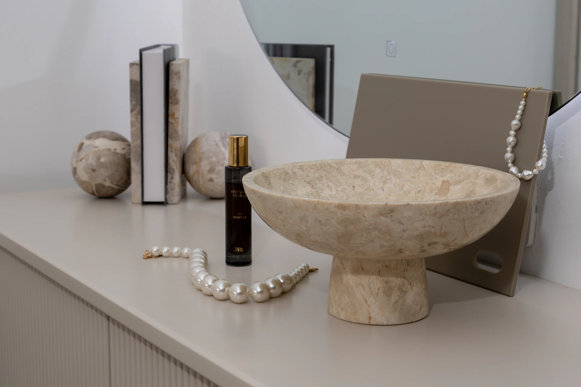 Decorative bowl with pearls and perfume bottle