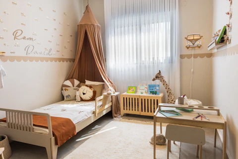Cozy child's bedroom with bed and desk.