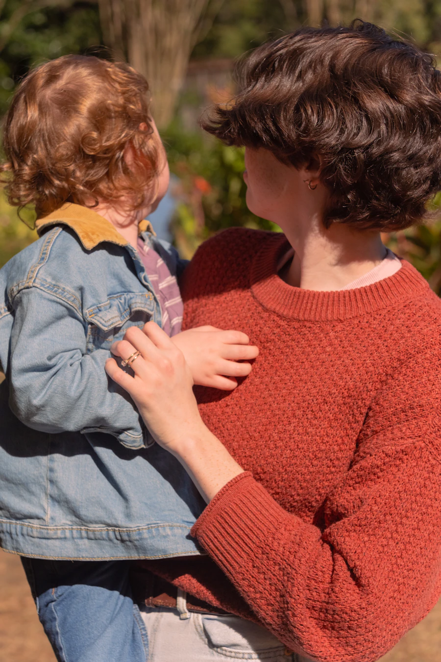 Mother holding a young child outdoors