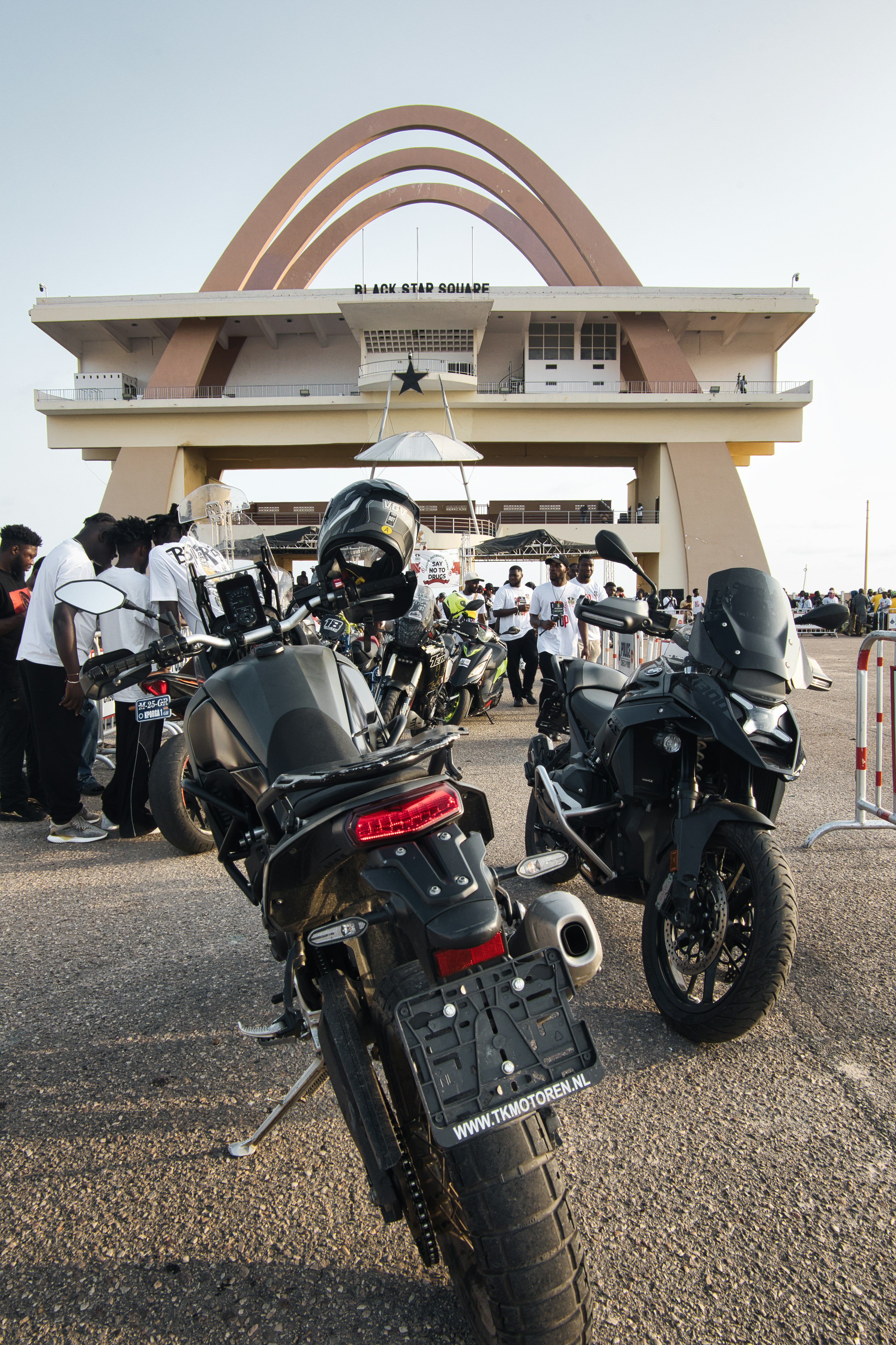 Motorcycles parked near independence arch, accra