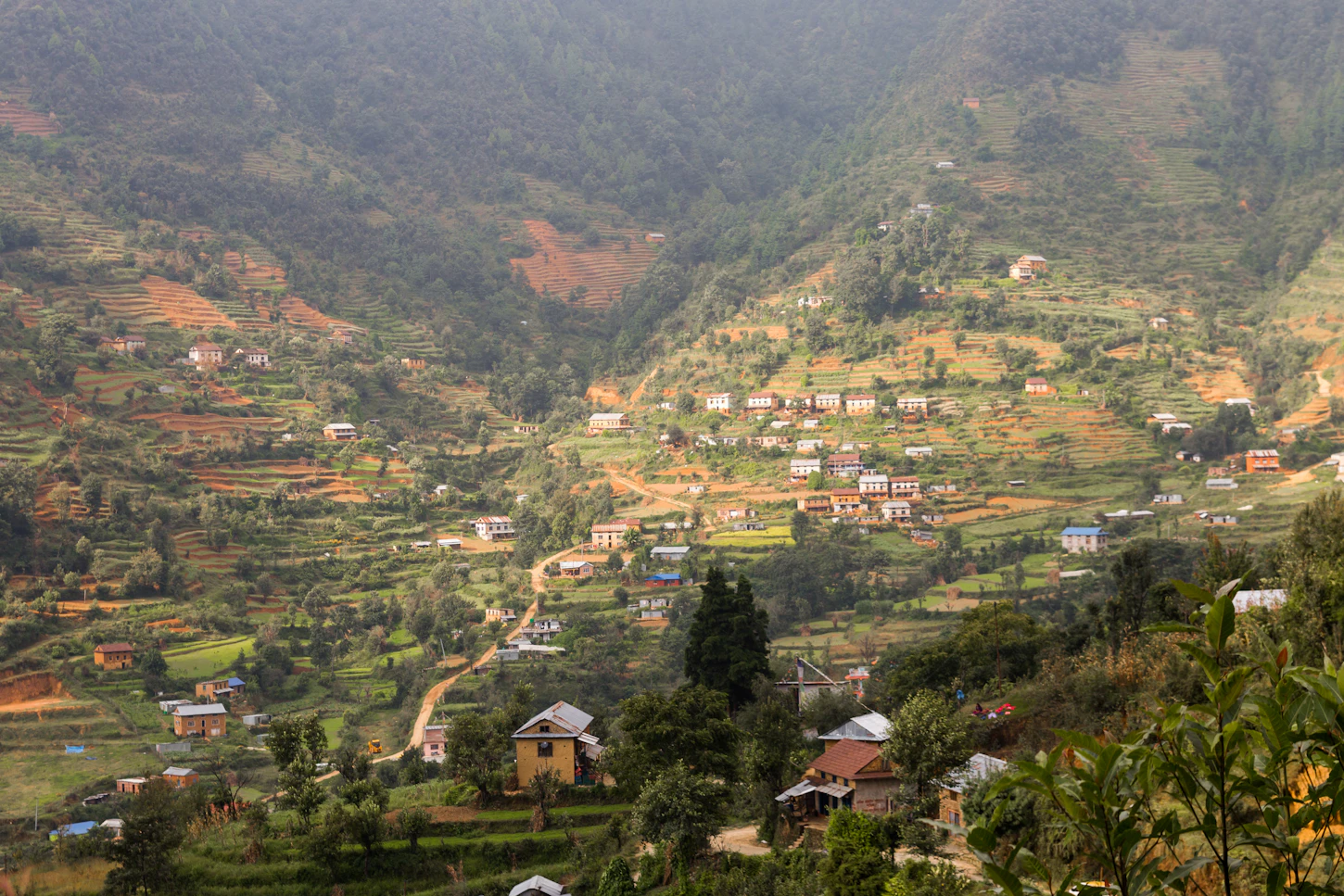 Houses and roads in a green mountain village in Lalitpur, Nepal