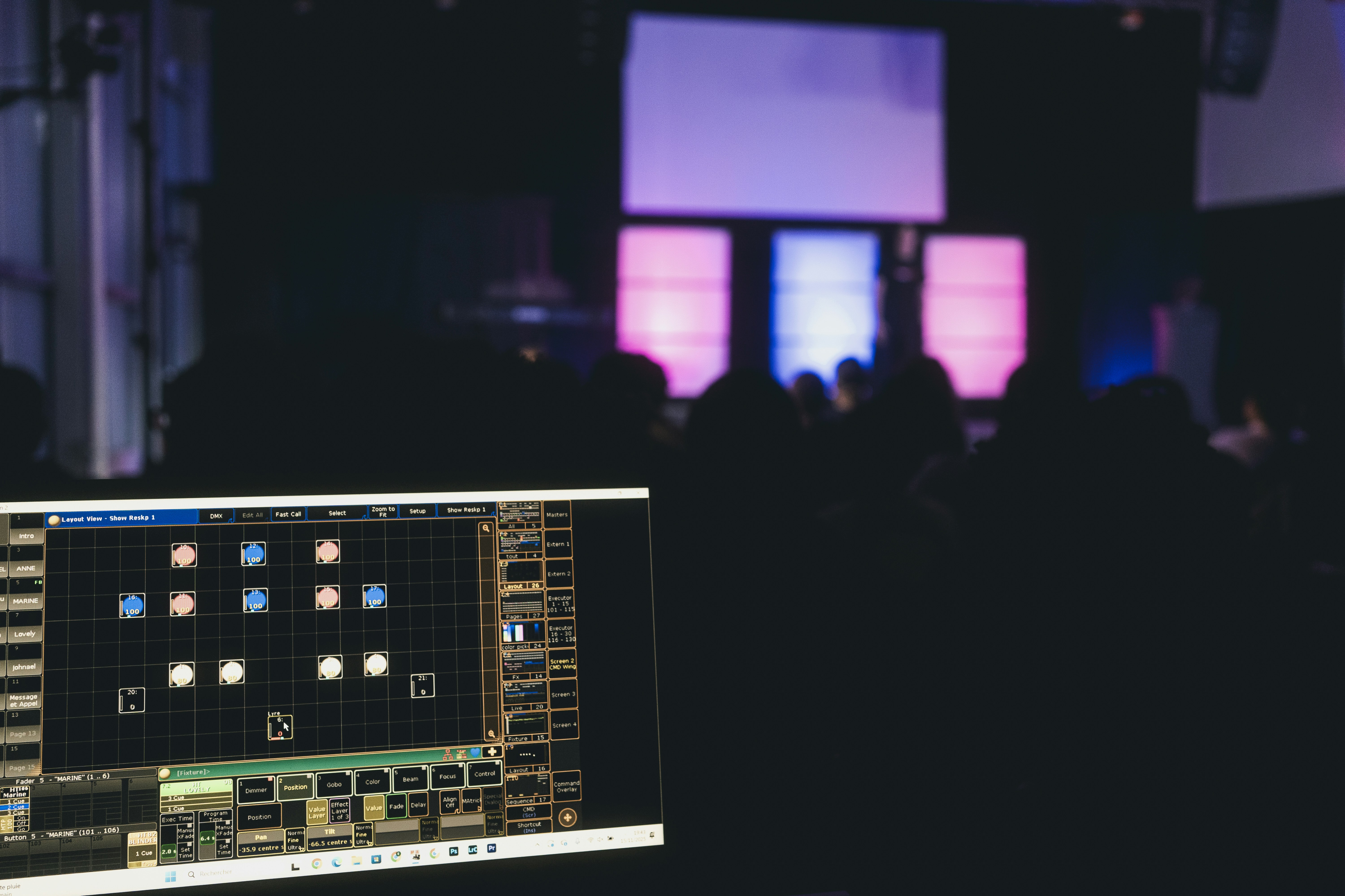 Stage lighting control board with blurred audience background