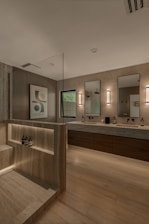 Modern bathroom with double vanity and shower area.